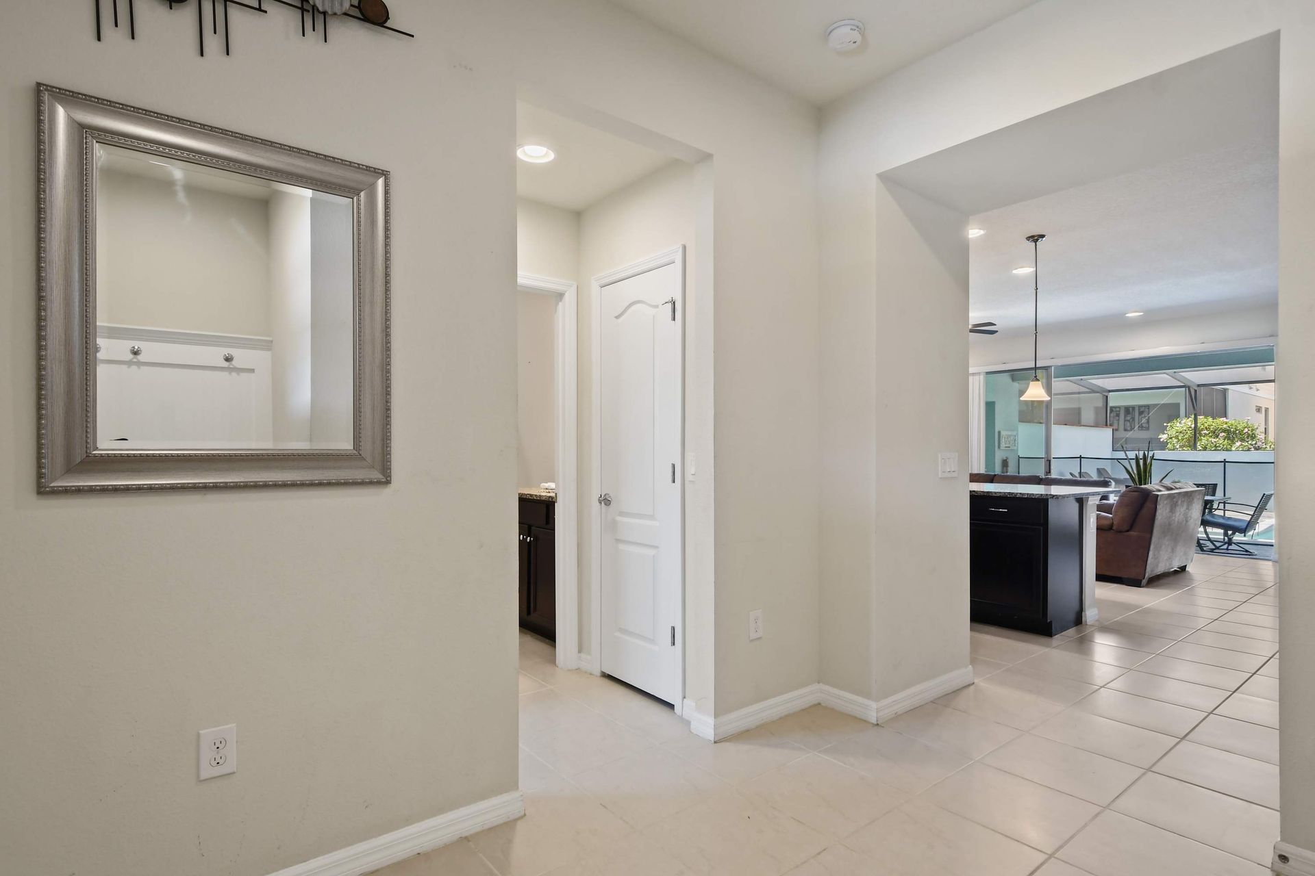 Bright, open entryway leading to spacious living and poolside relaxation.