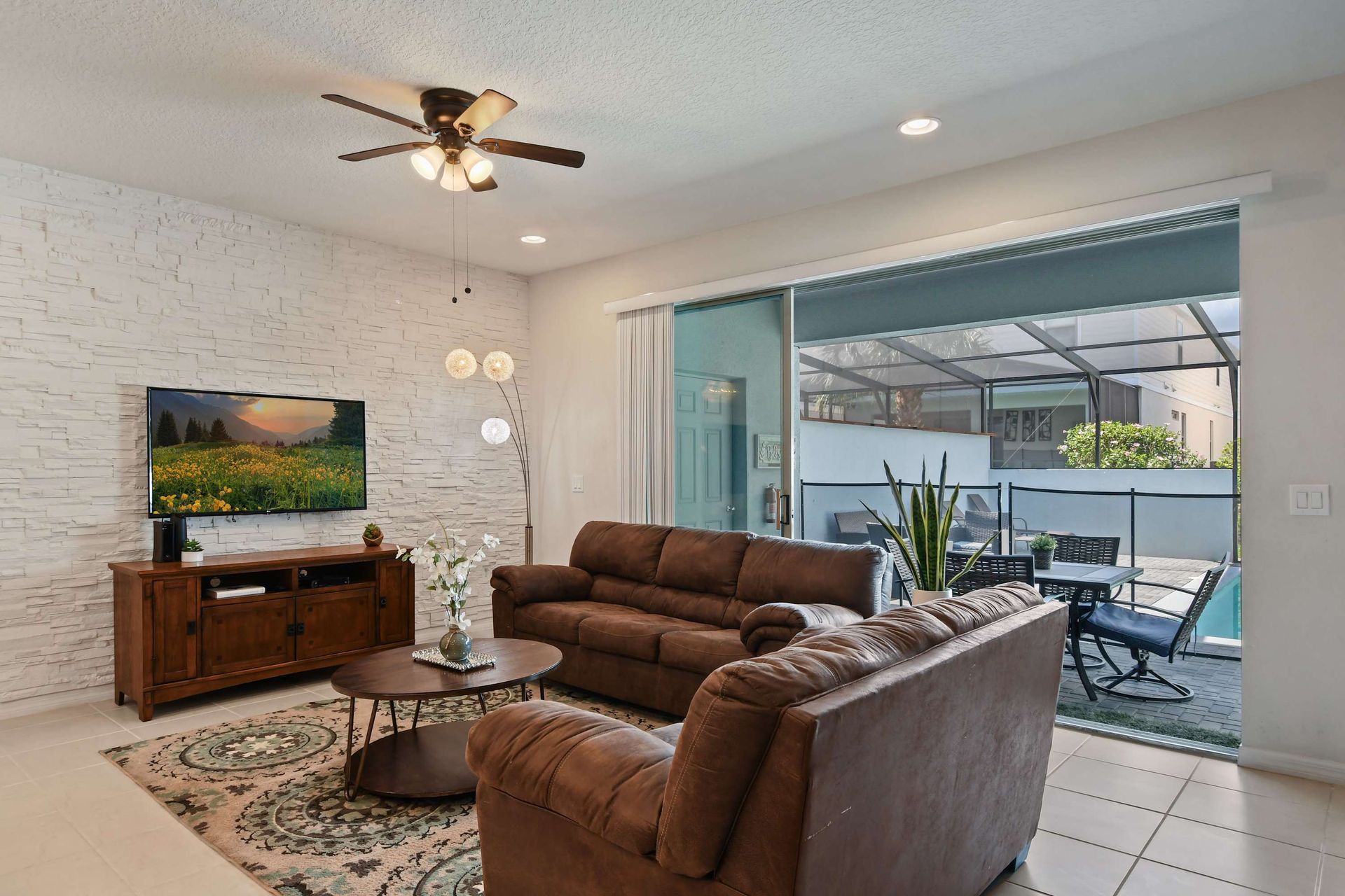 Cozy living space with poolside access, perfect for relaxing and entertaining guests.