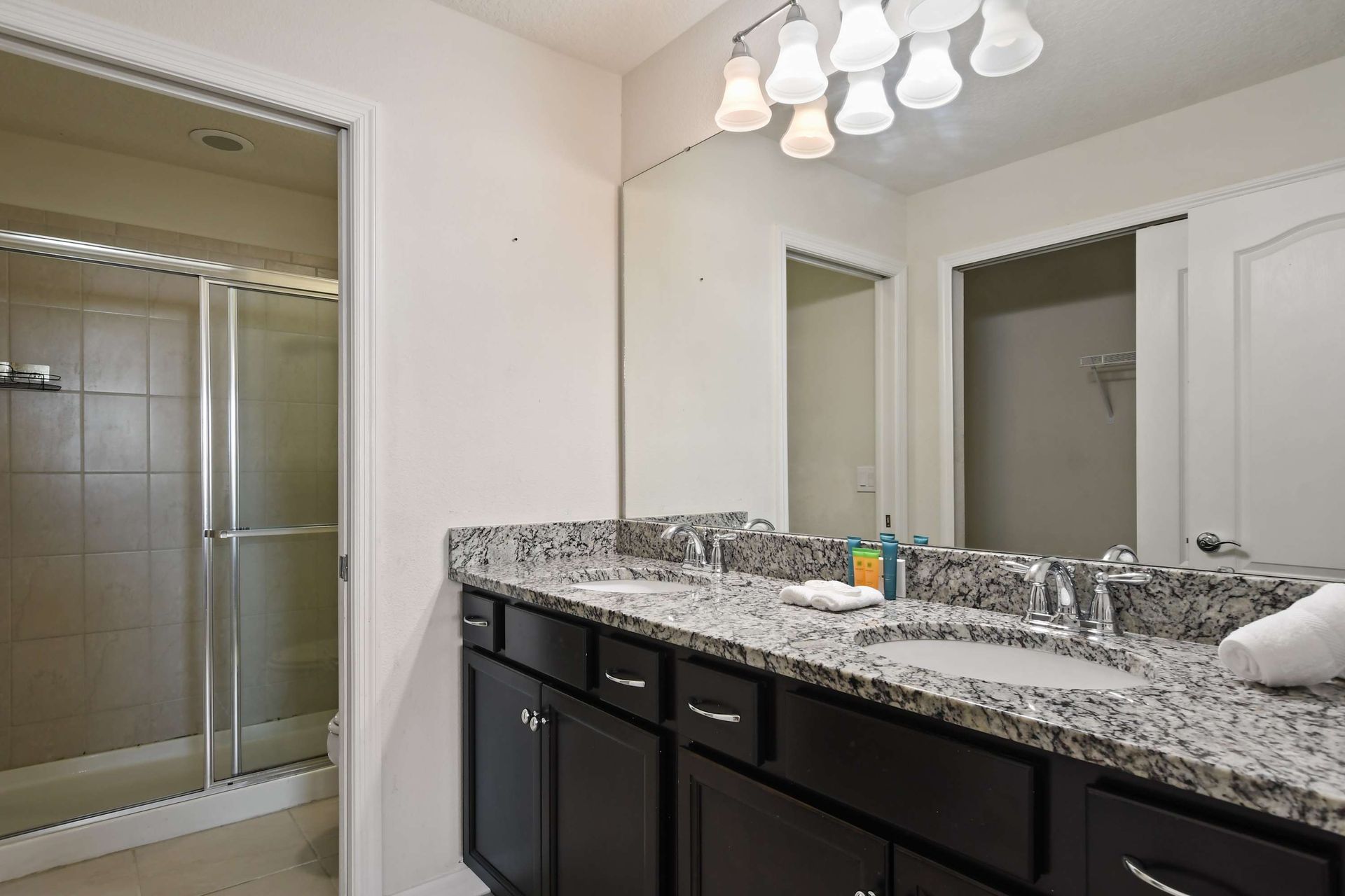 Spacious double-sink bathroom with walk-in shower, perfect for relaxing moments.