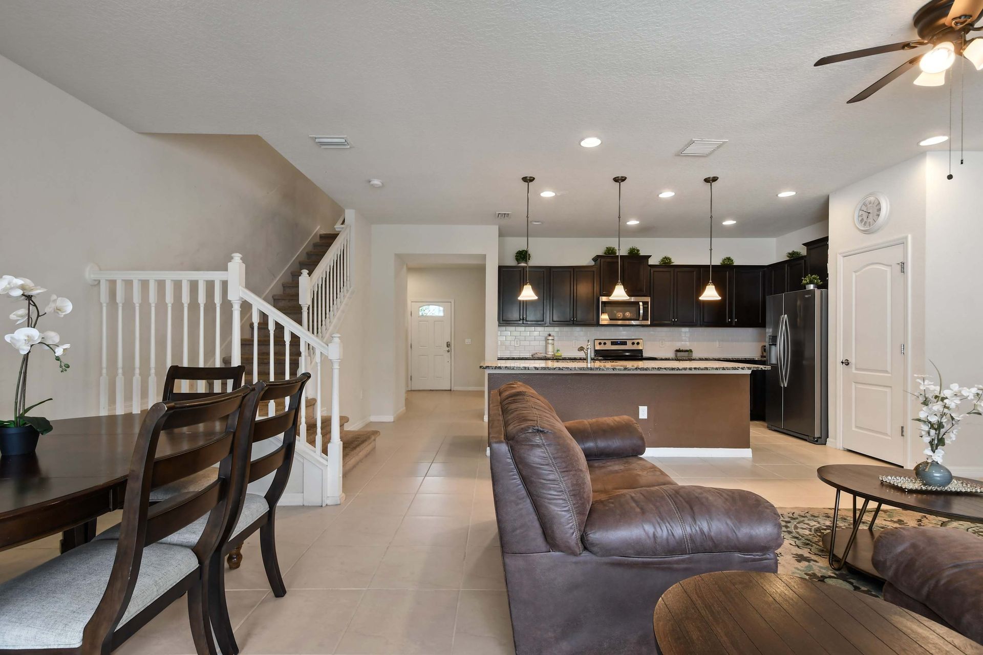 Elegant open kitchen and dining area with warm lighting and inviting modern style.