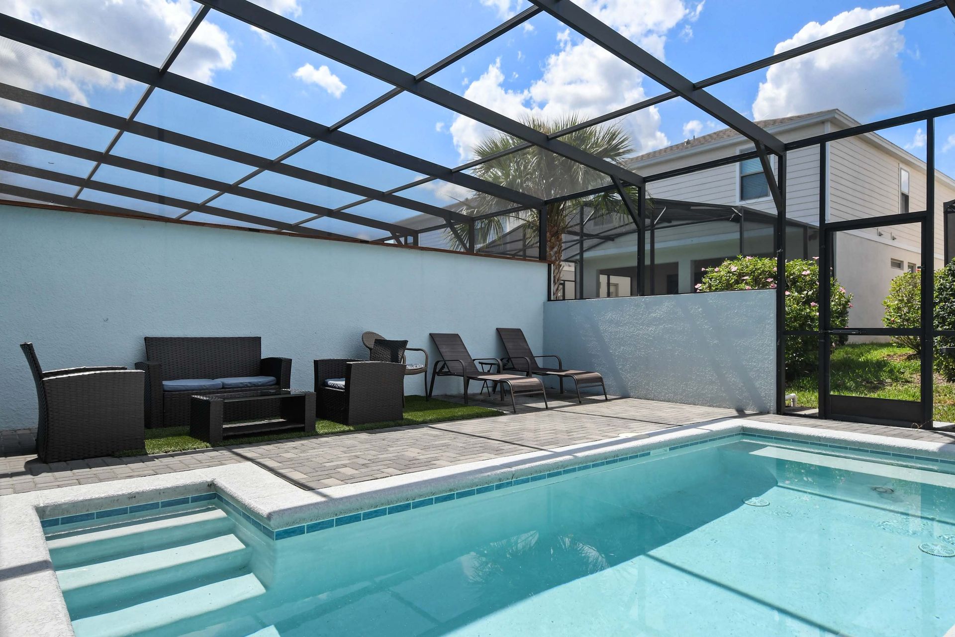Sparkling private pool with loungers and comfy seating, ideal for sunny relaxation.