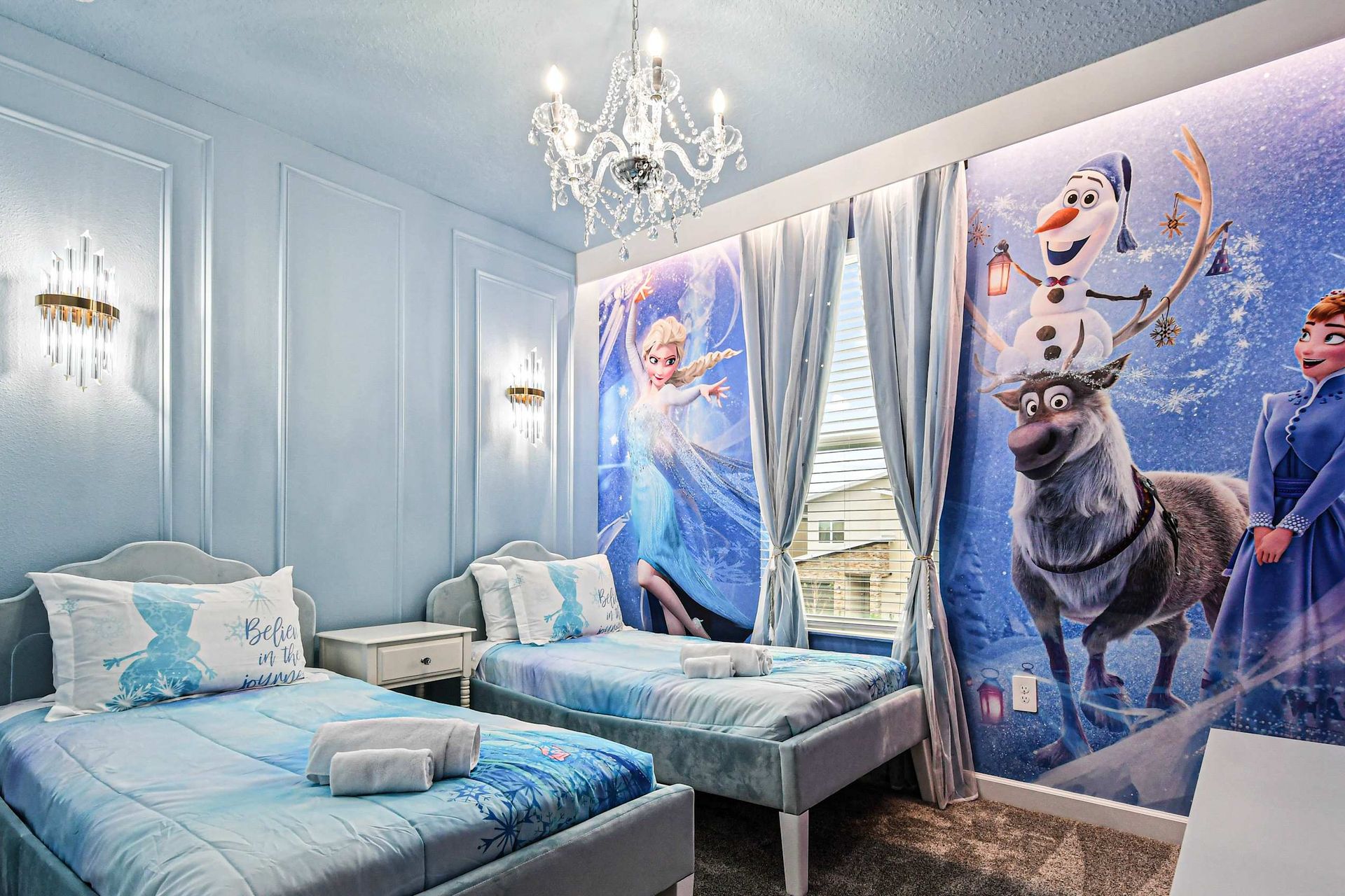 Magical Frozen-themed kids’ room with twin beds, shimmering décor, and charm.
