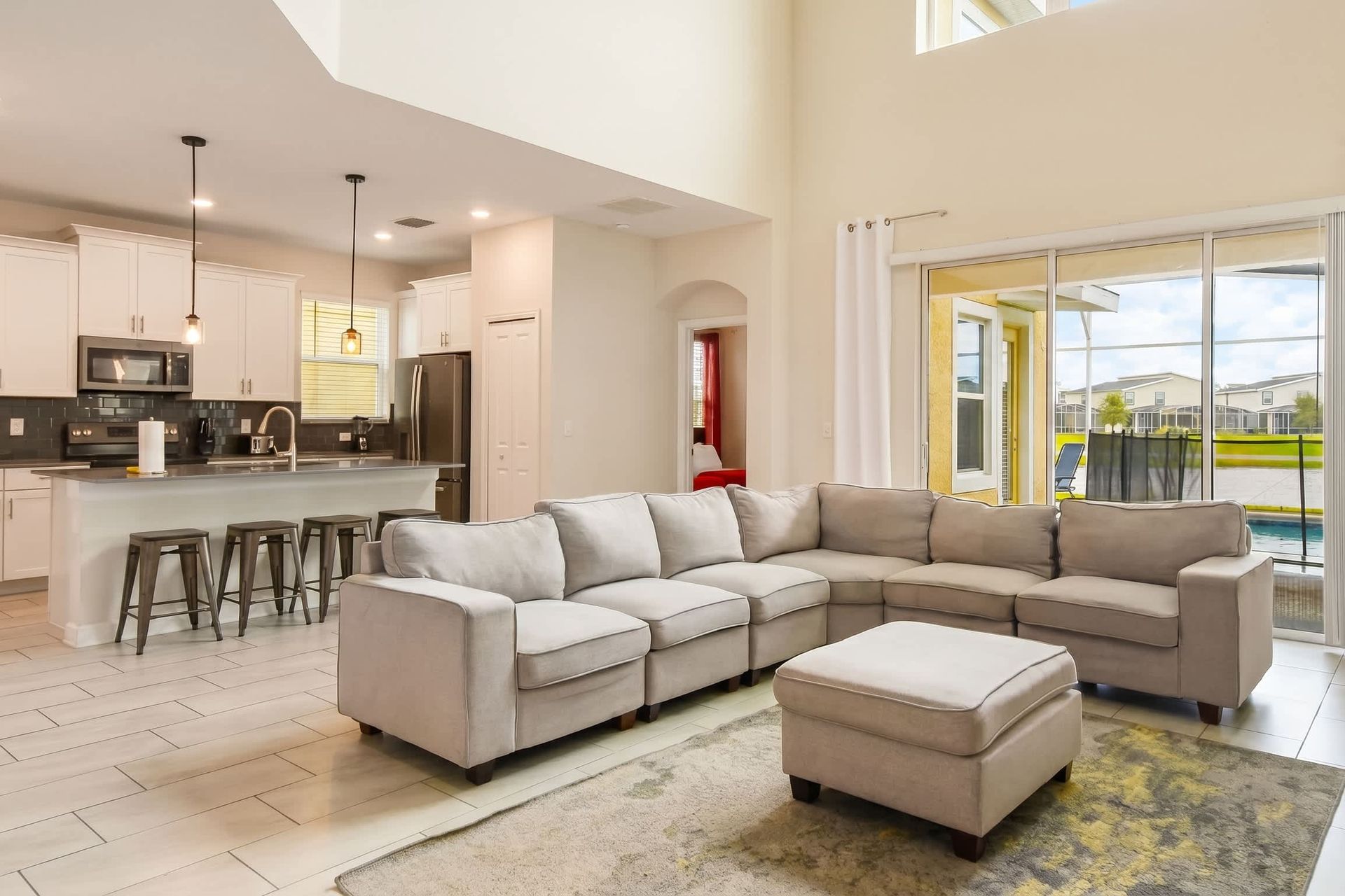 The spacious and elegantly designed living room serves as the heart of the home. It features a large, comfortable sofa.