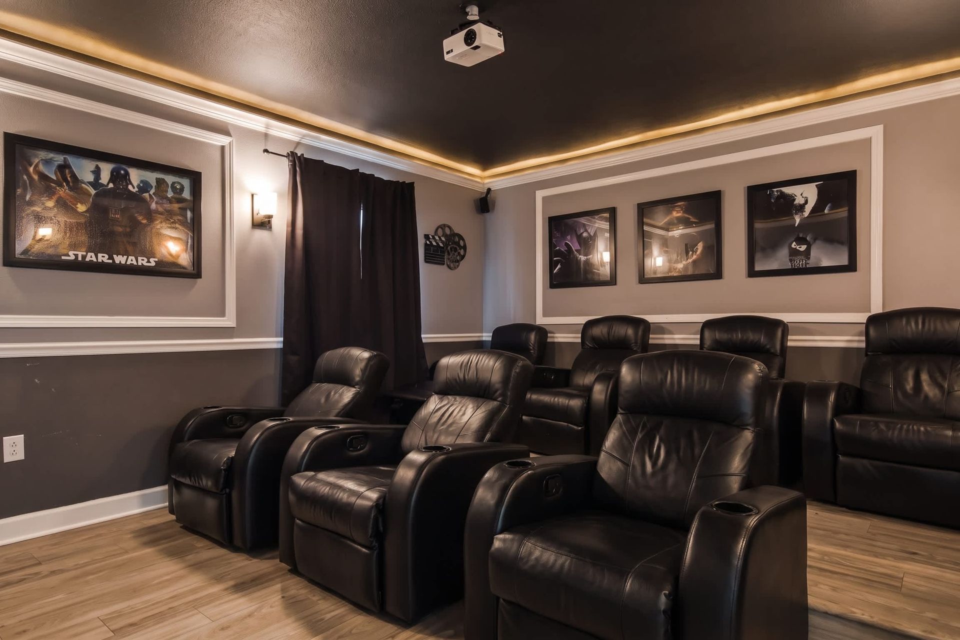 Dedicated movie theater equipped with plush seating, a large screen.