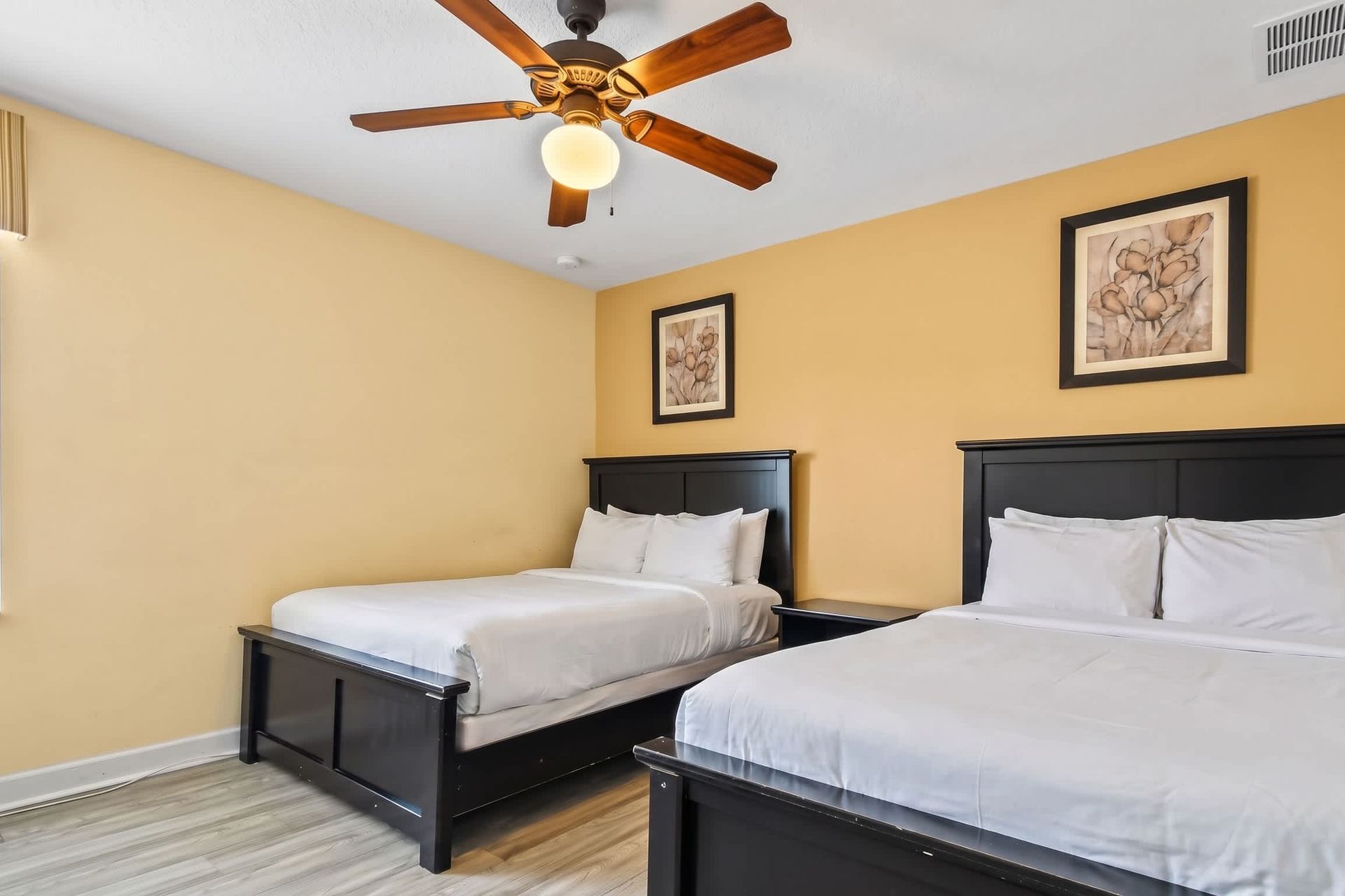 Bedroom featuring two double beds, equipped with its own TV