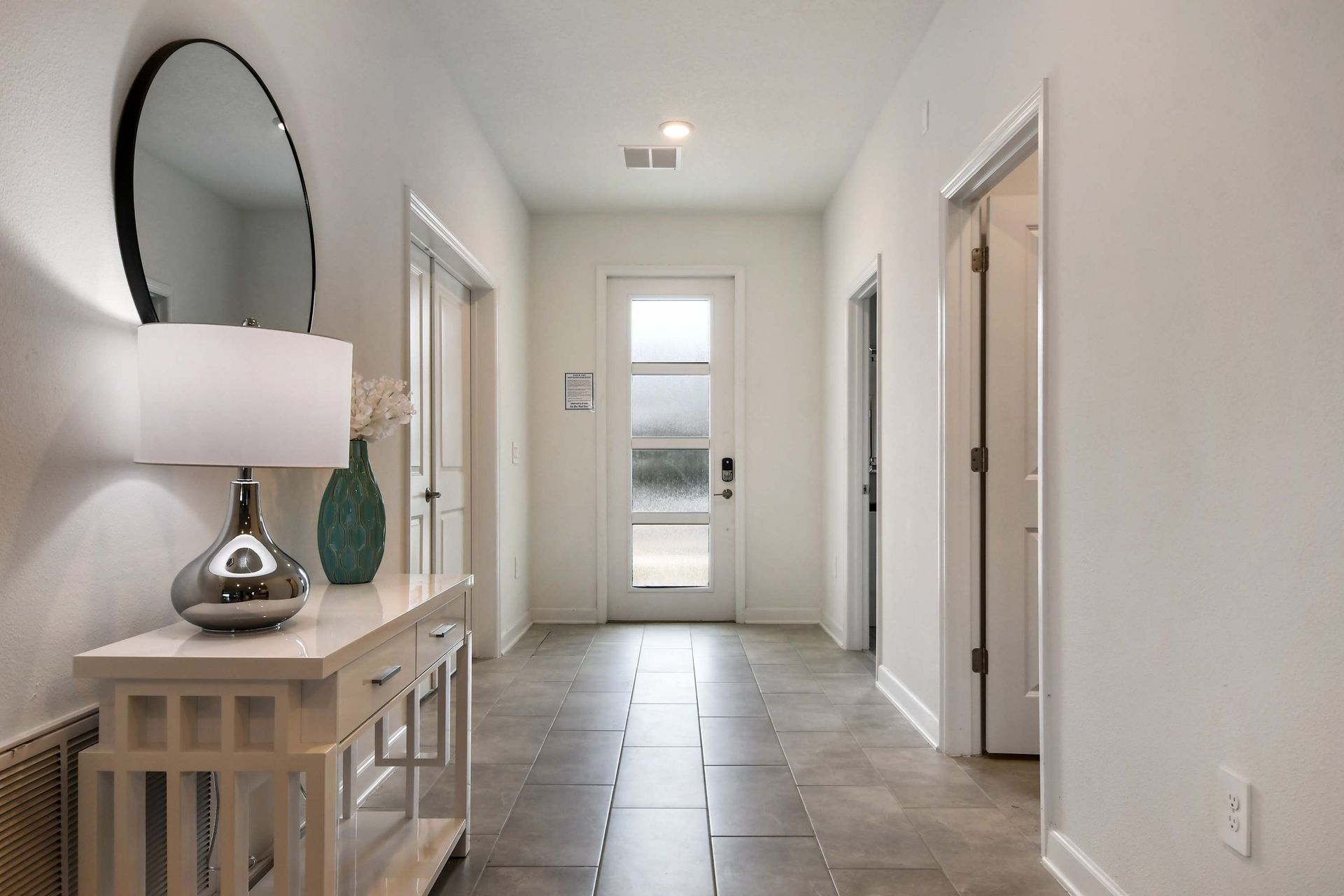 Bright, modern entryway with elegant decor welcomes you to your stylish stay.