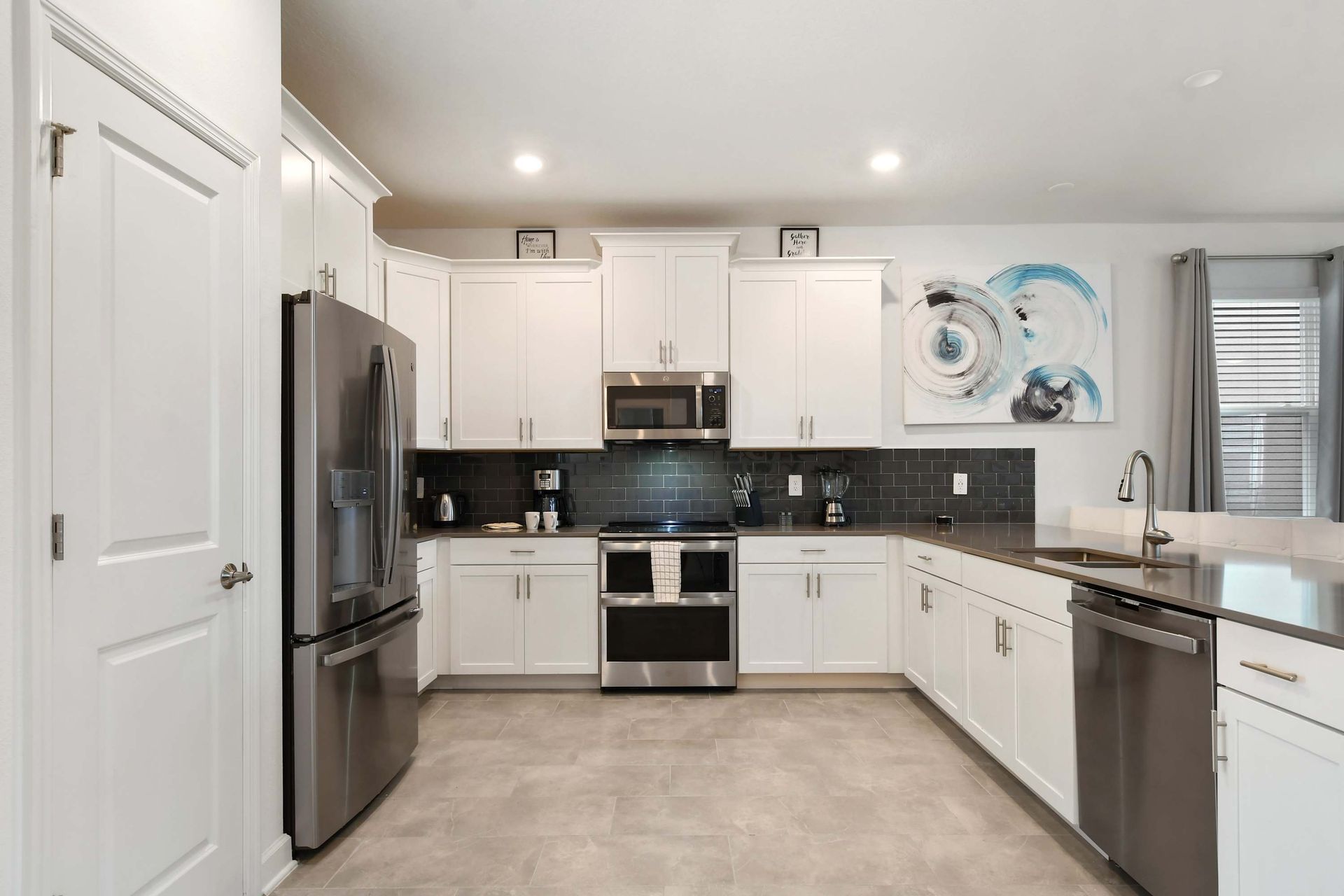 Modern chef’s kitchen with stainless steel appliances, sleek counters, and style.