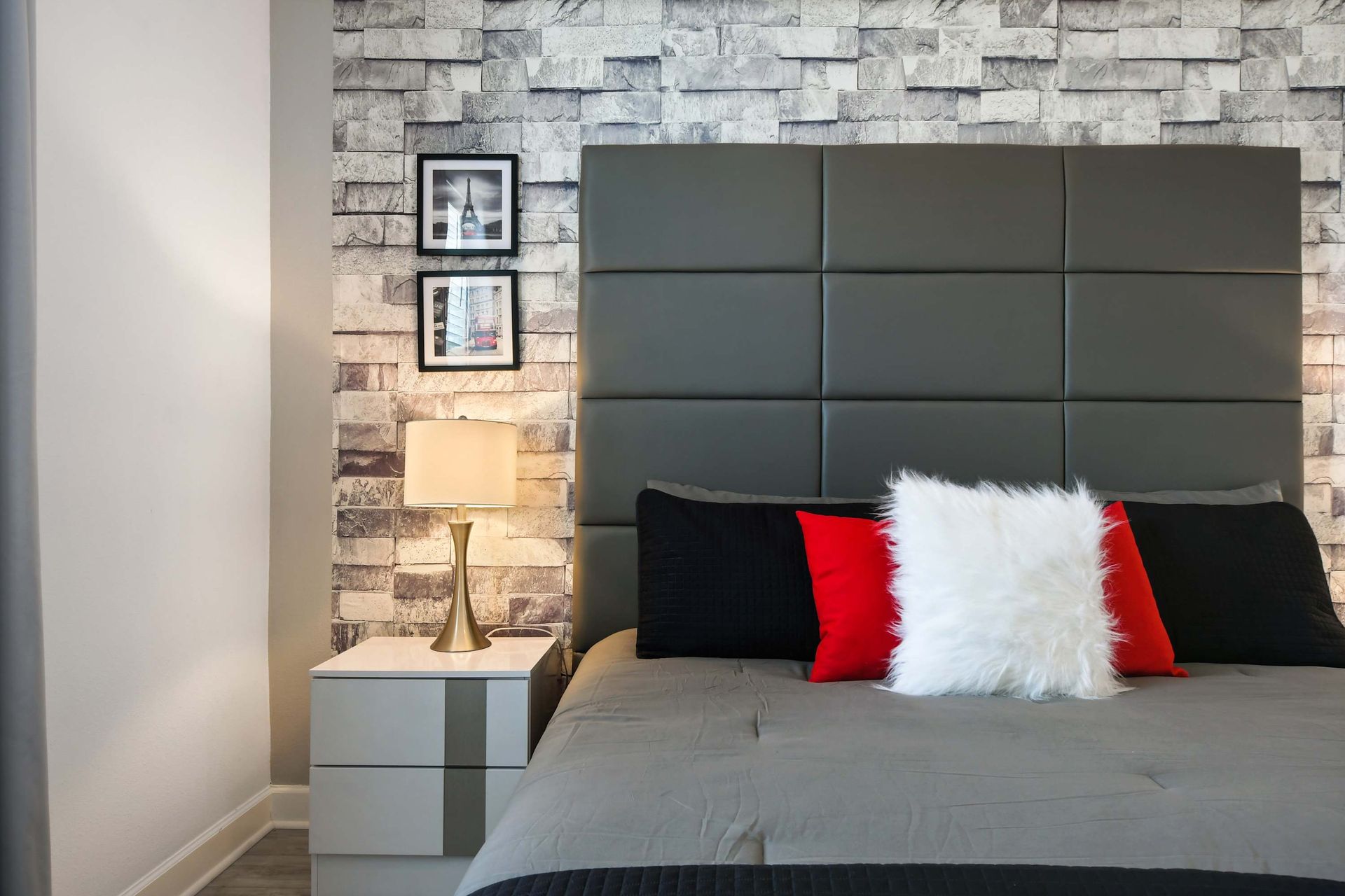 Modern bedroom with sleek decor, textured accent wall, and cozy king-size bed.