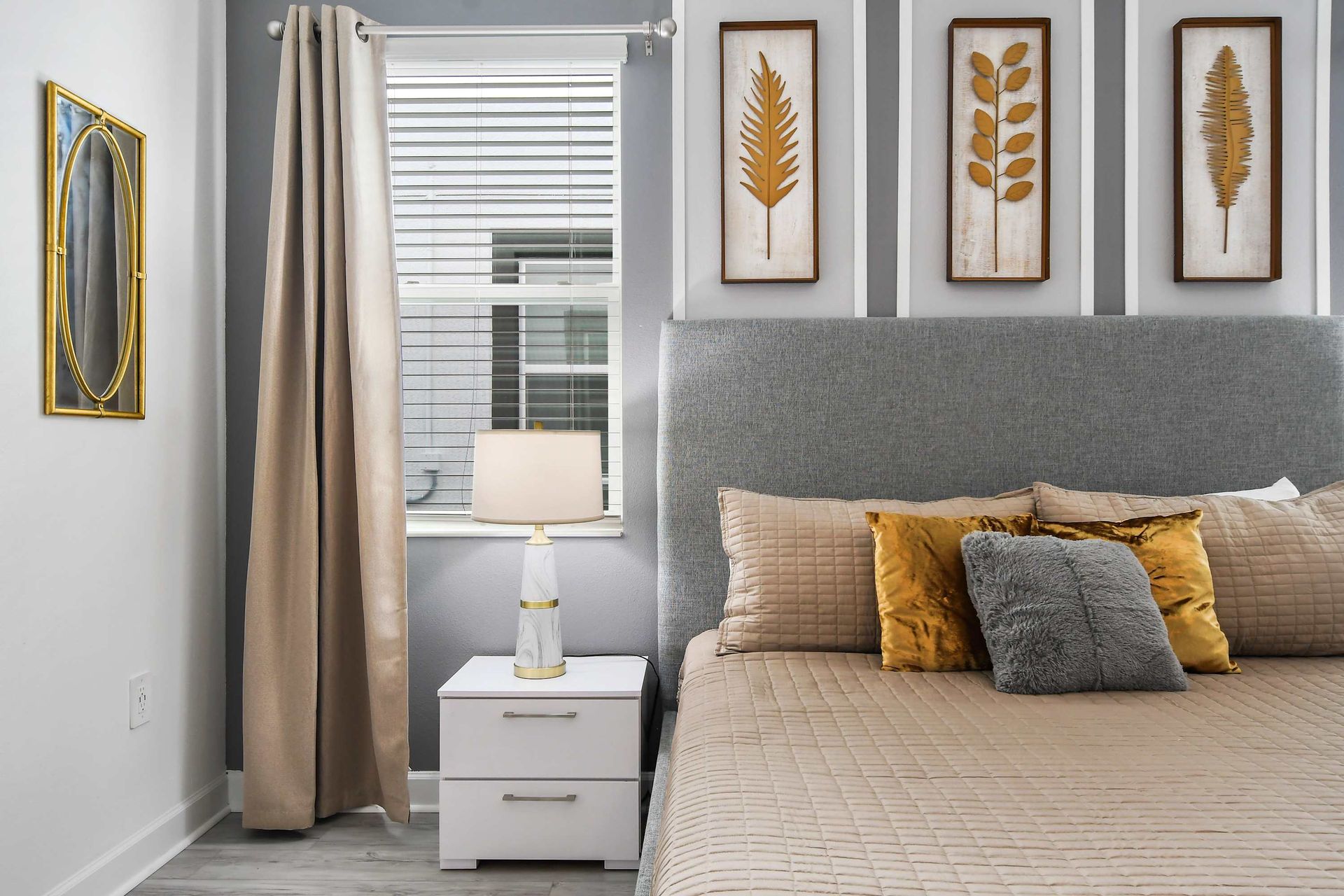 Serene bedroom with neutral tones, king bed, ensuite bath, and a cozy crib.
