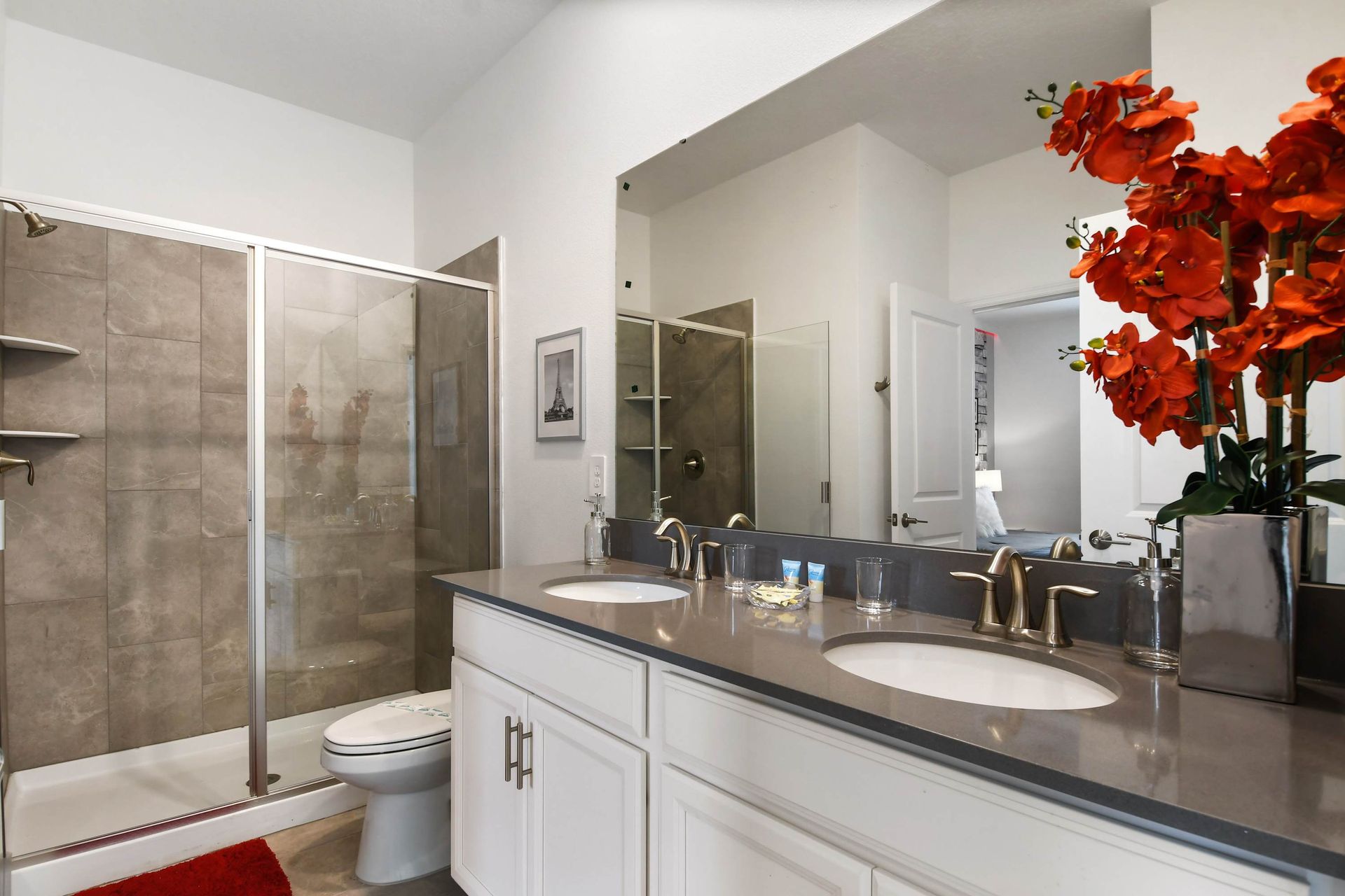 Stylish double-vanity bathroom with a sleek glass shower and modern touches.