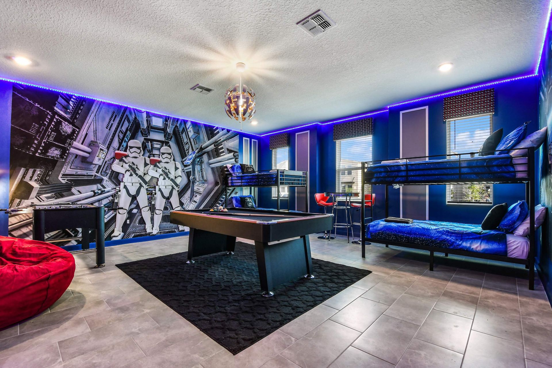 Epic galactic game room with bunk beds, pool table, foosball, and LED lighting.
