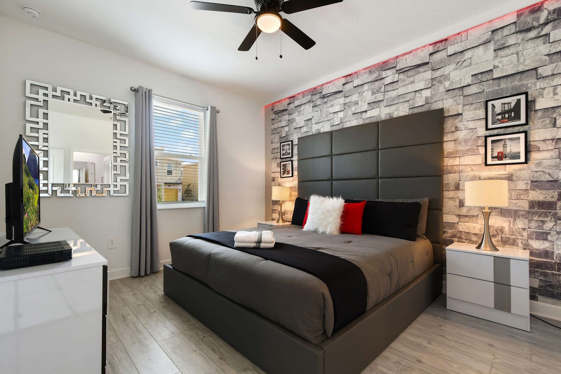 Modern bedroom with sleek decor, textured accent wall, and cozy king-size bed.