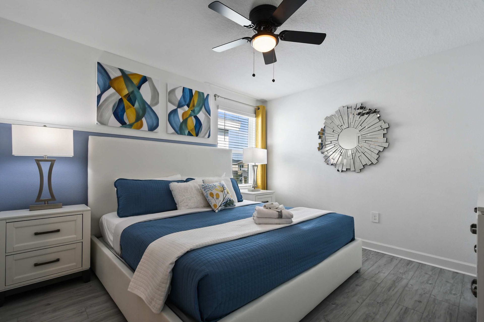 Bright modern bedroom with king bed, bold accents, and artistic contemporary flair.