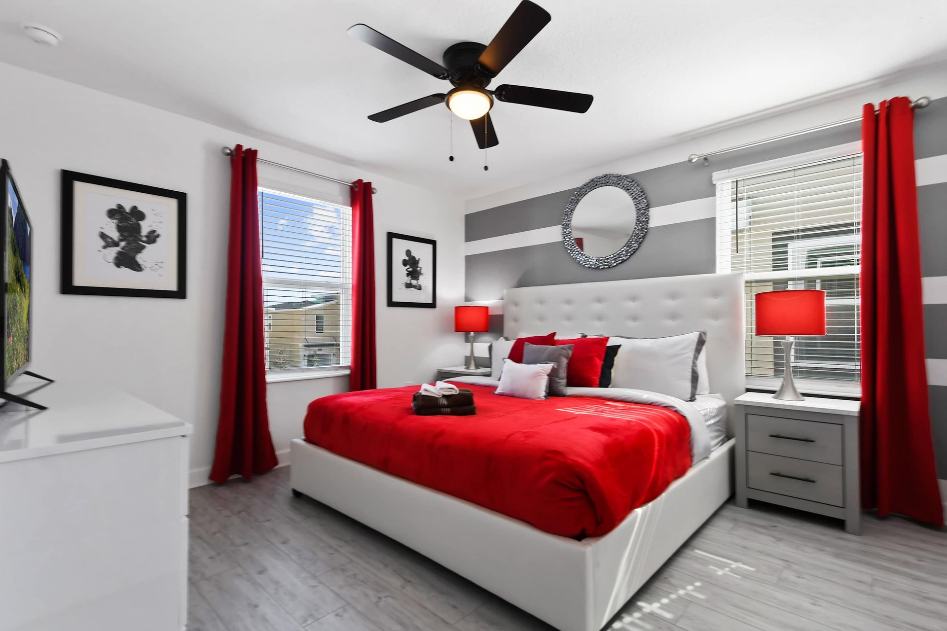 Vibrant red and white bedroom with bold stripes, king bed, and modern flair.