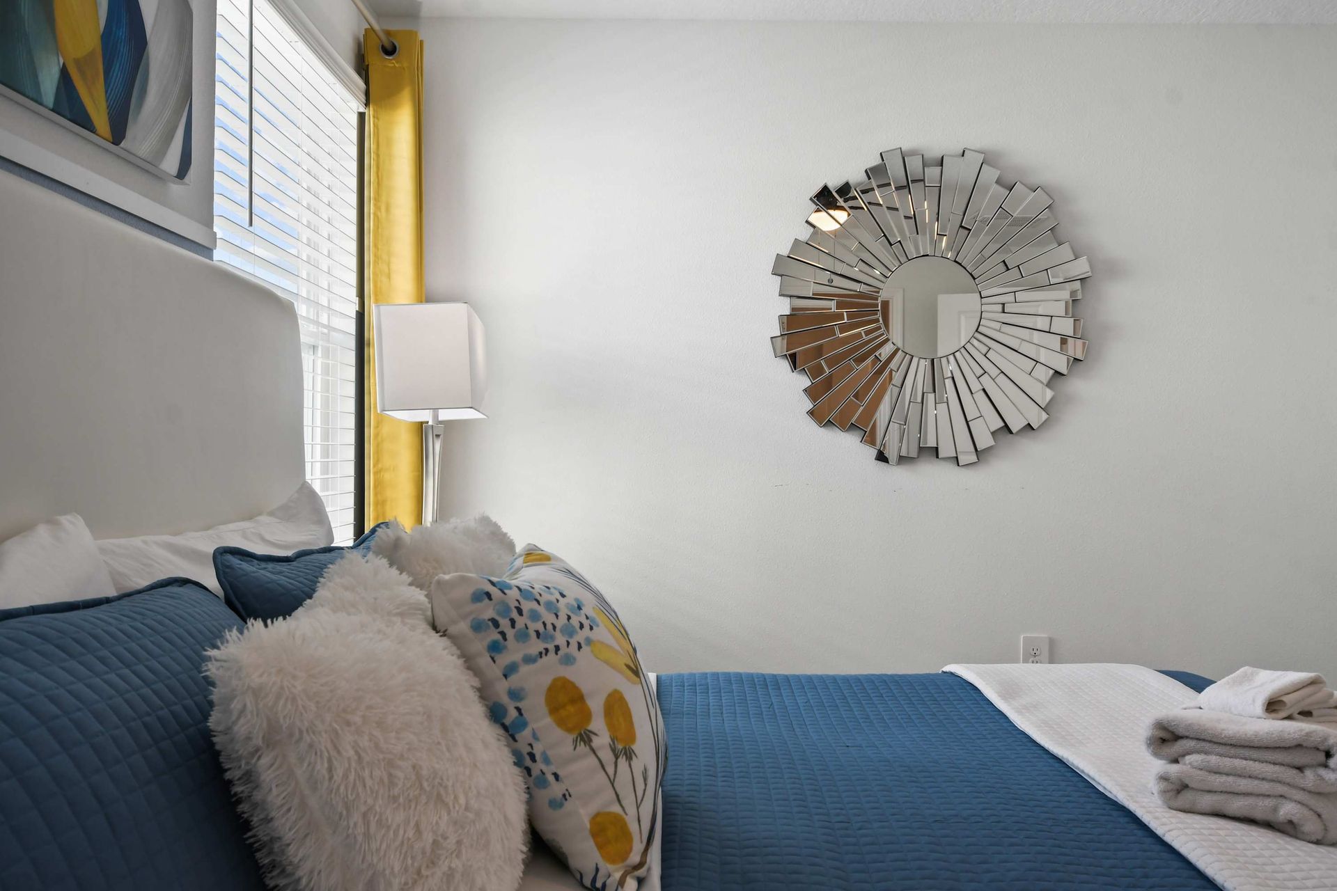Bright modern bedroom with king bed, bold accents, and artistic contemporary flair.