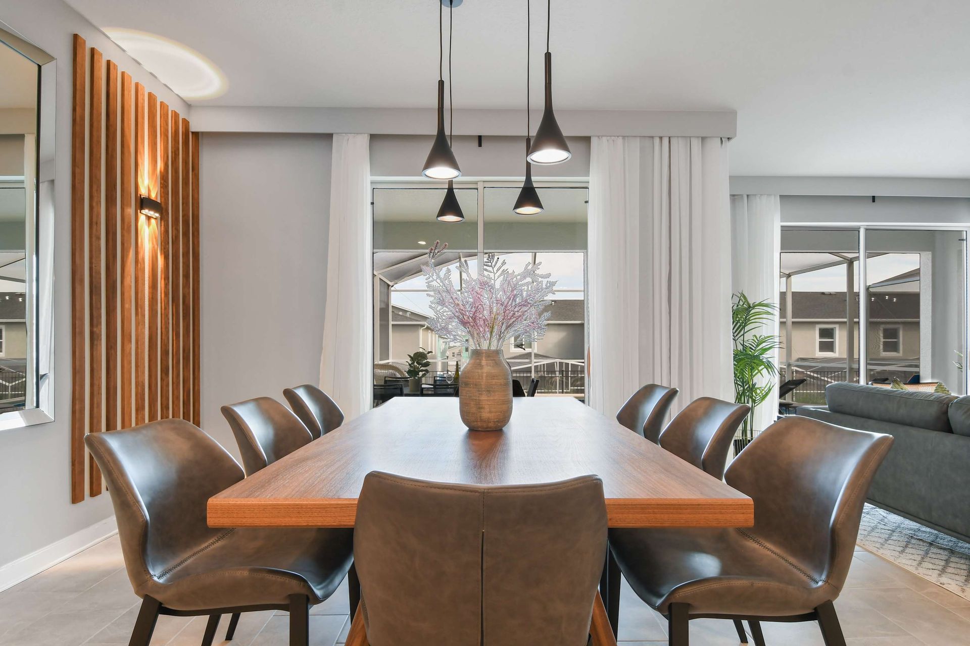 Elegant dining area with modern lighting, sleek seating, and natural wood touches.
