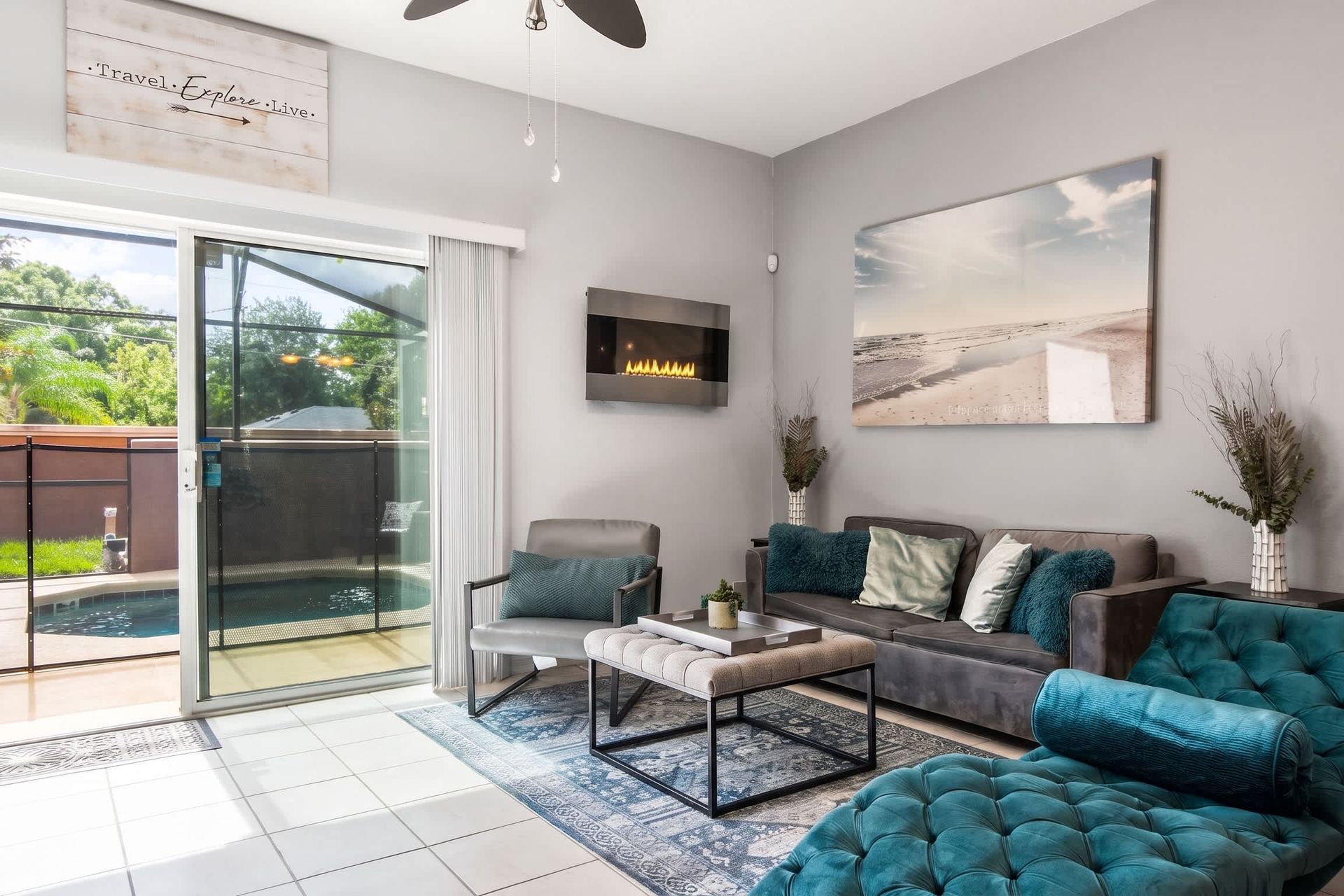 Relaxing living room with a sleek fireplace and poolside access!