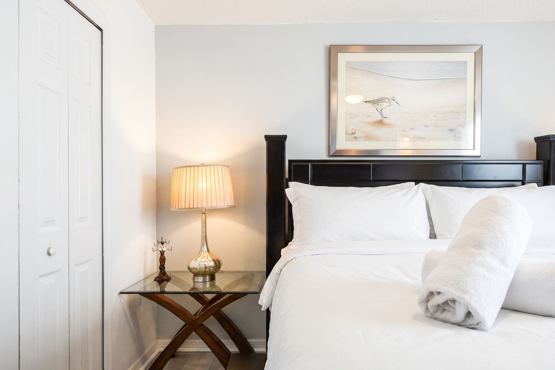 Chic bedroom with elegant decor, soft lighting, and cozy bedding!