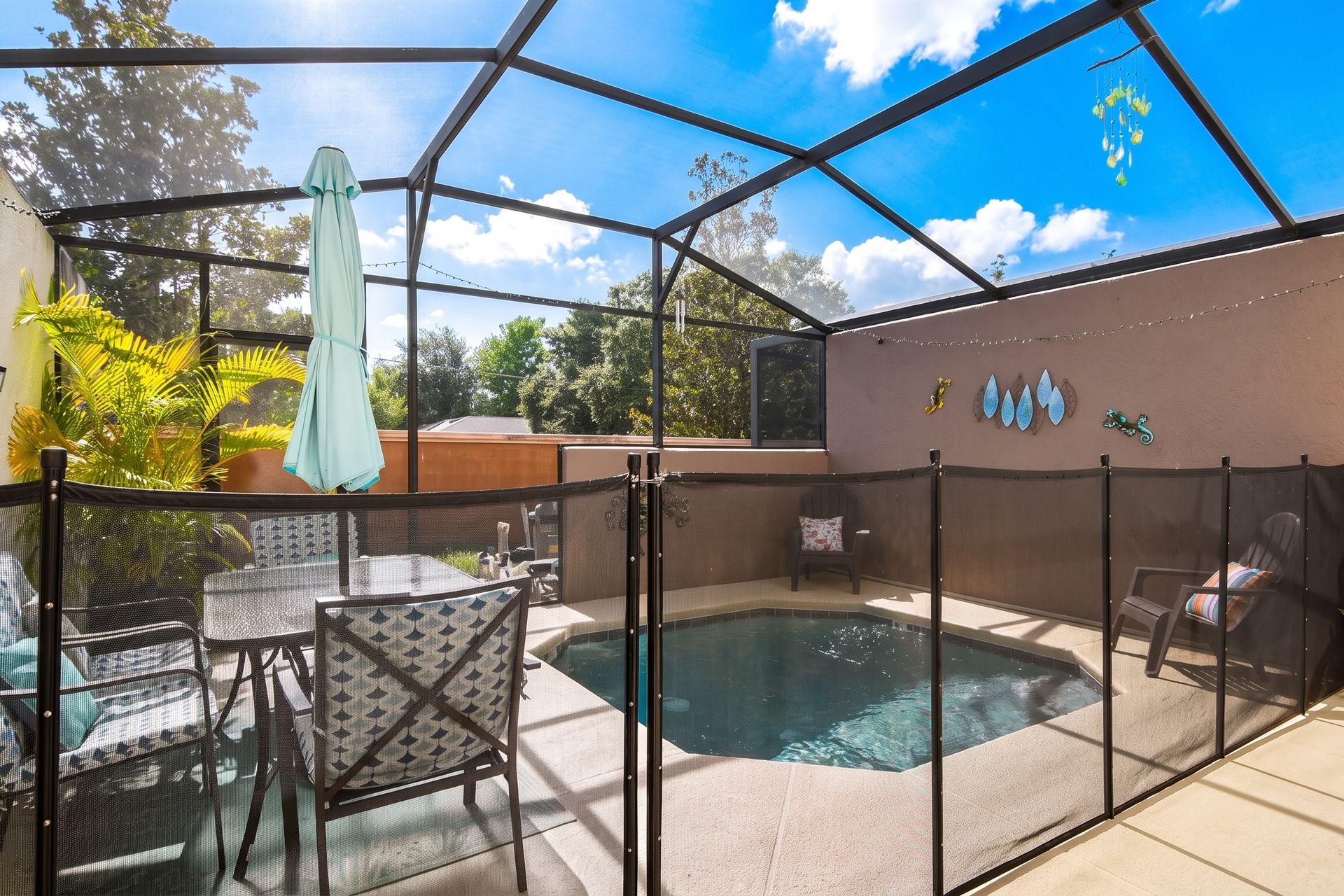 Private screened-in pool with cozy seating and vibrant decor!