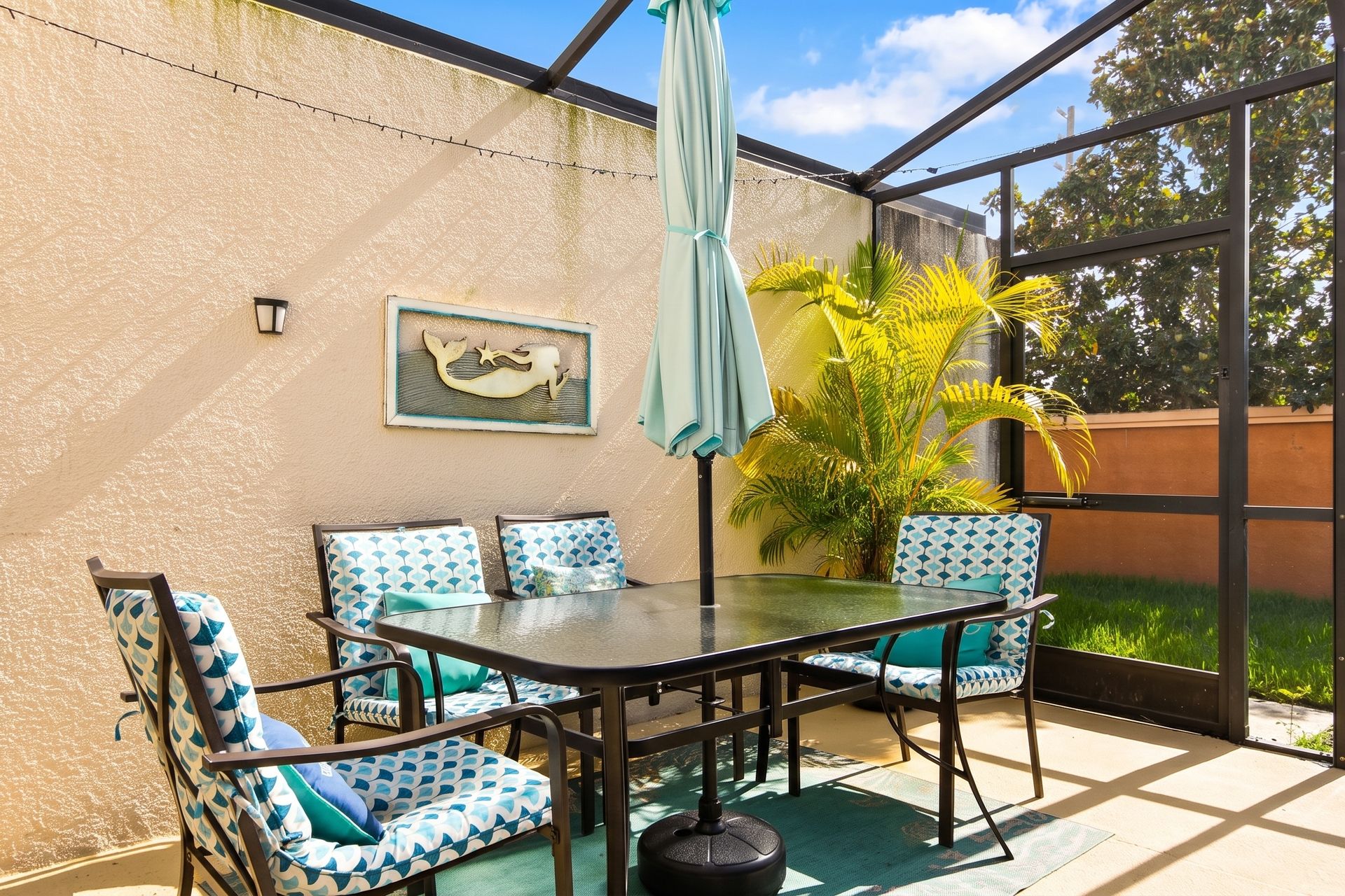 Relaxing outdoor dining space with vibrant seating and tropical vibes!