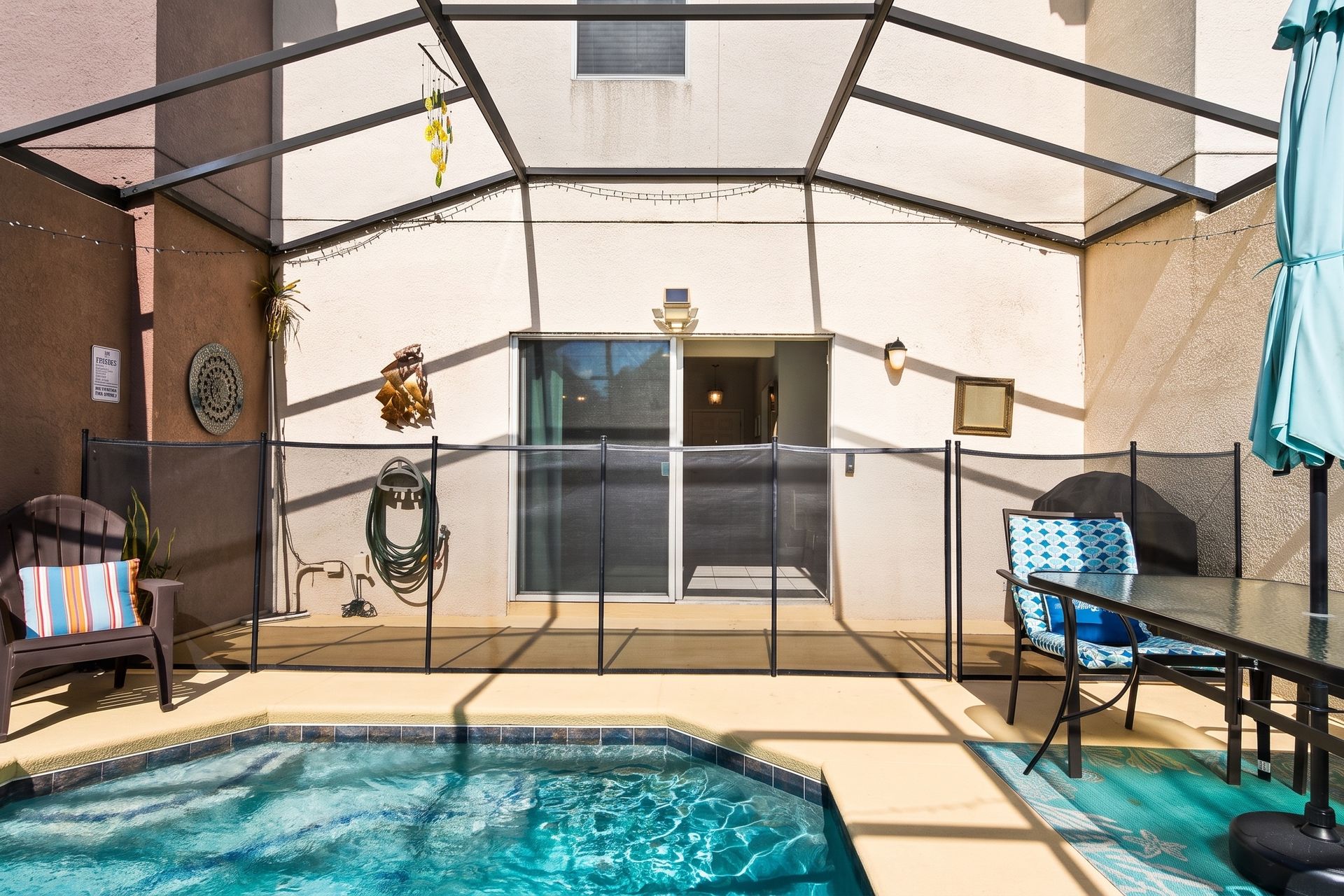 Inviting pool area with safety fencing, cozy seating, and decor!