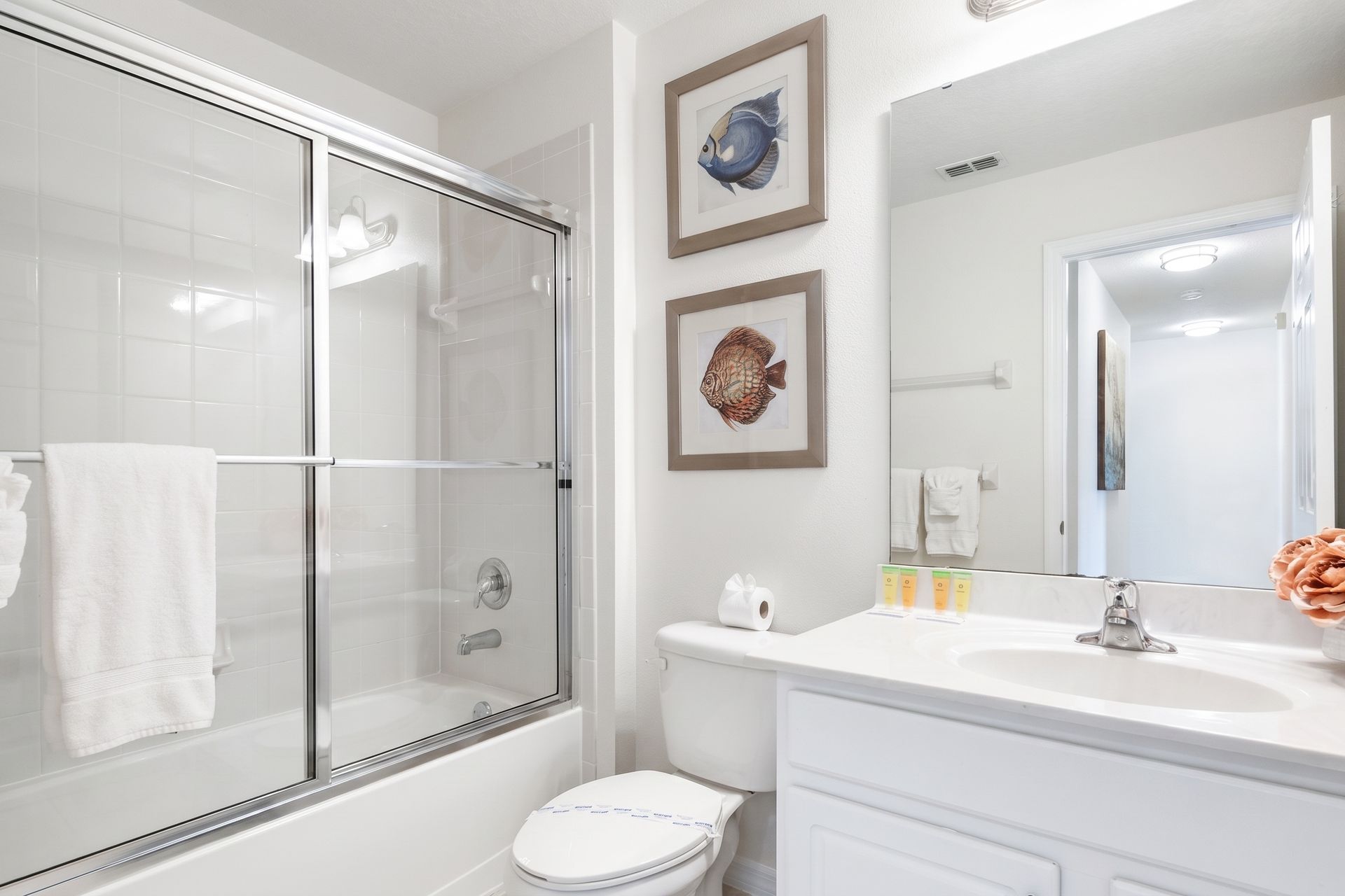 Bright and clean bathroom with a tub, modern accents, and decor!