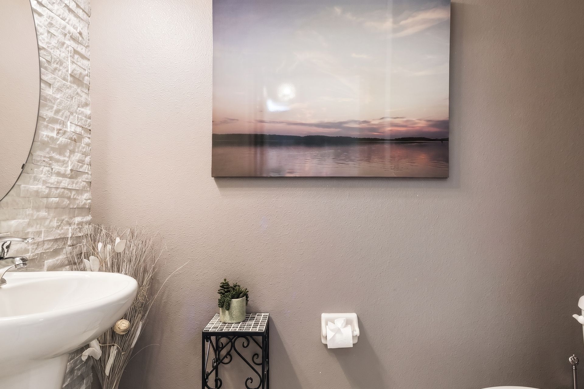 Cozy powder room with elegant textures and serene wall art!