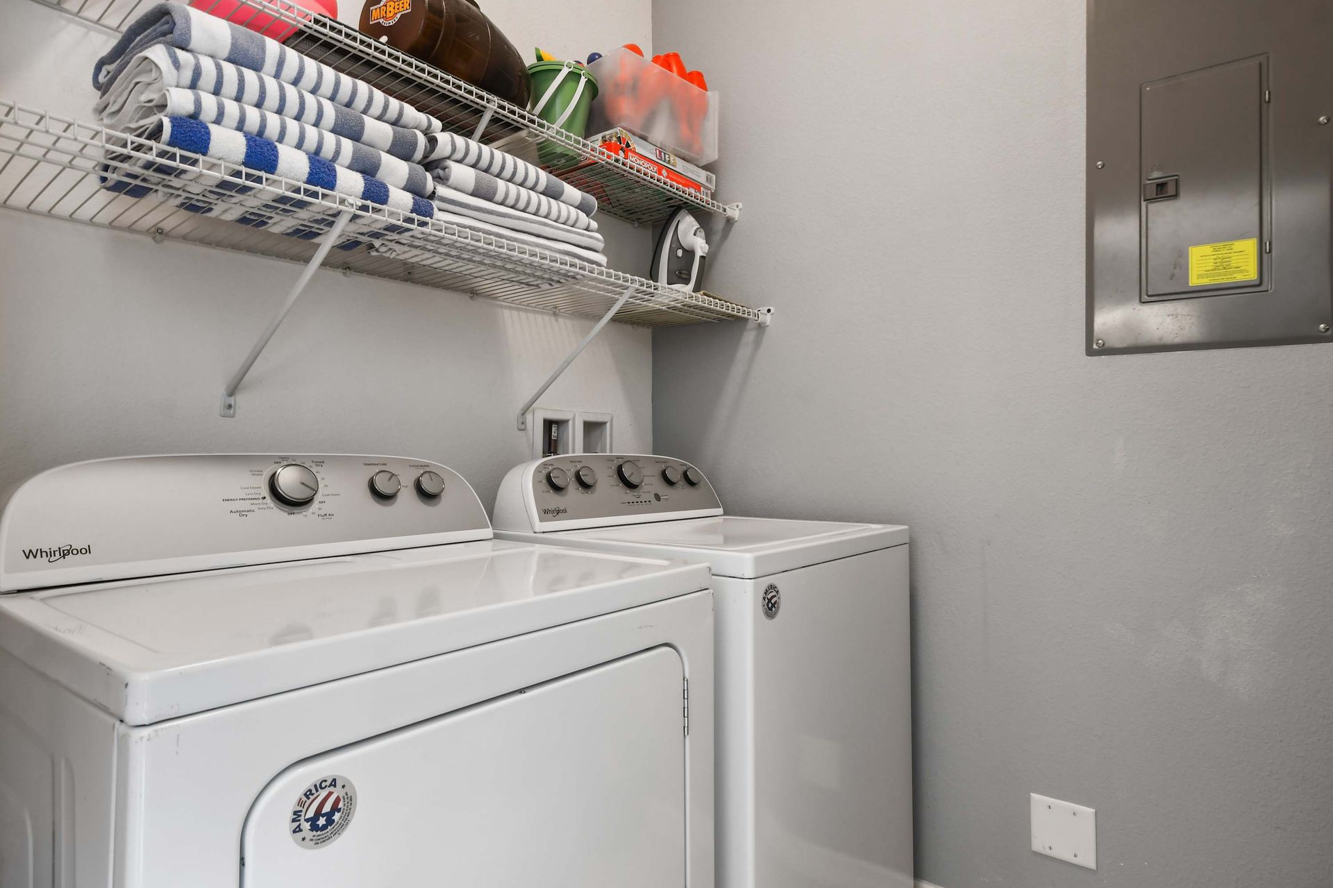Convenient laundry room with washer, dryer, and organized shelving!