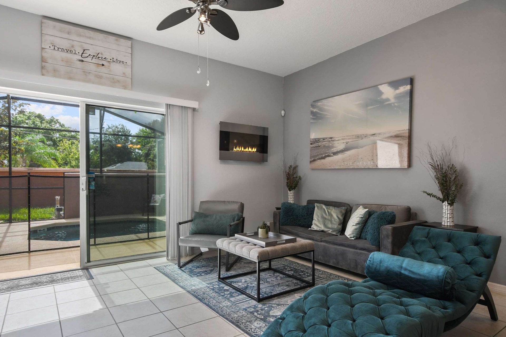 Relaxing living room with a sleek fireplace and poolside access!