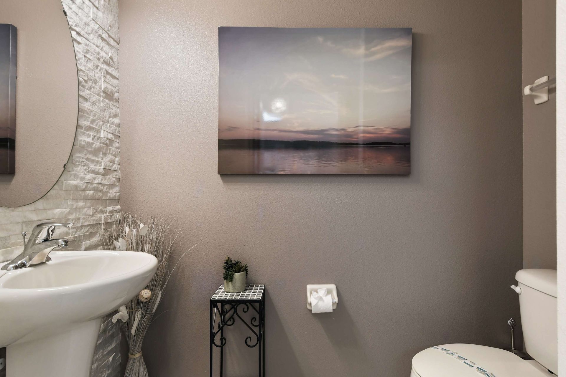 Cozy powder room with elegant textures and serene wall art!