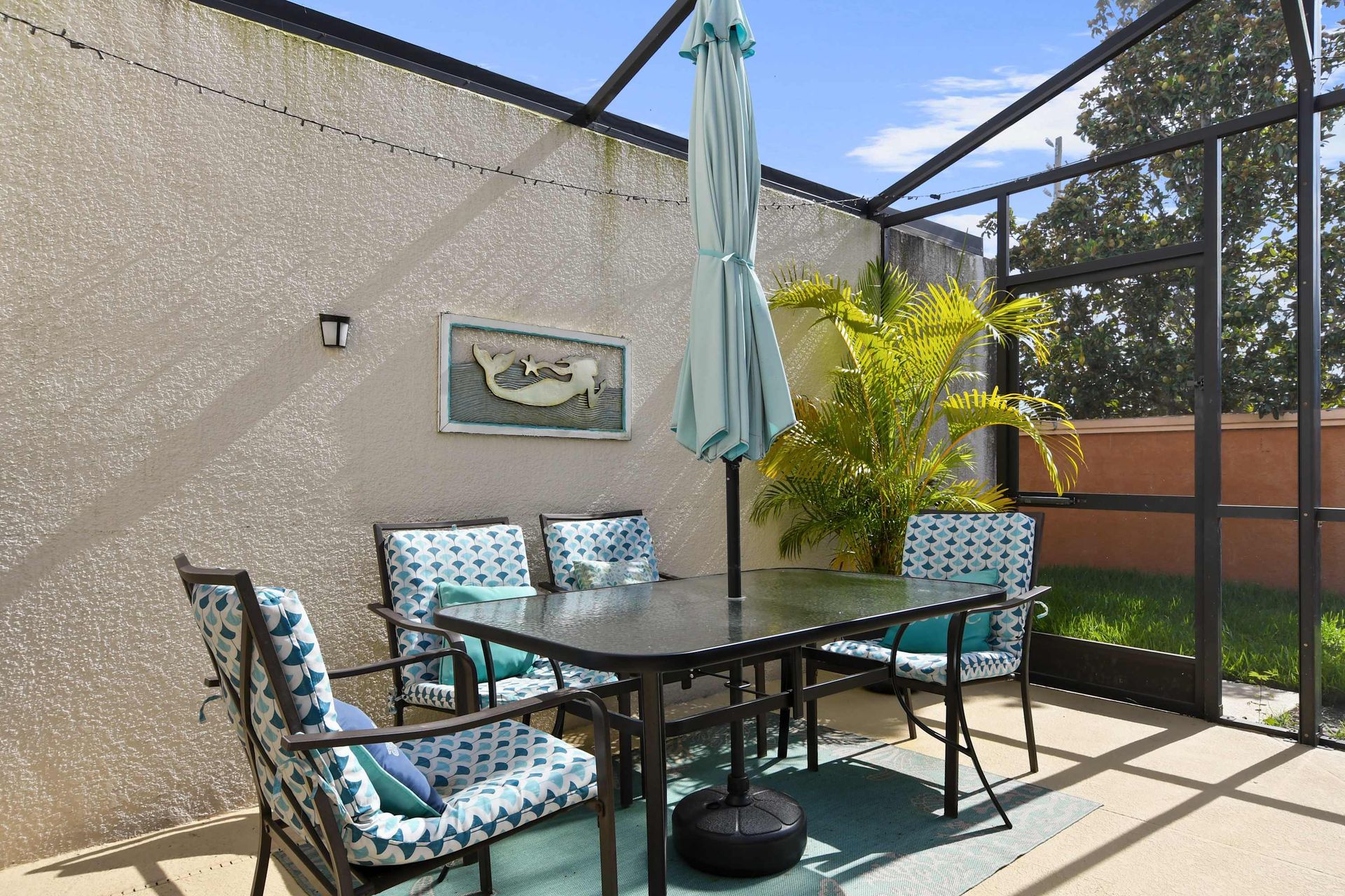Relaxing outdoor dining space with vibrant seating and tropical vibes!