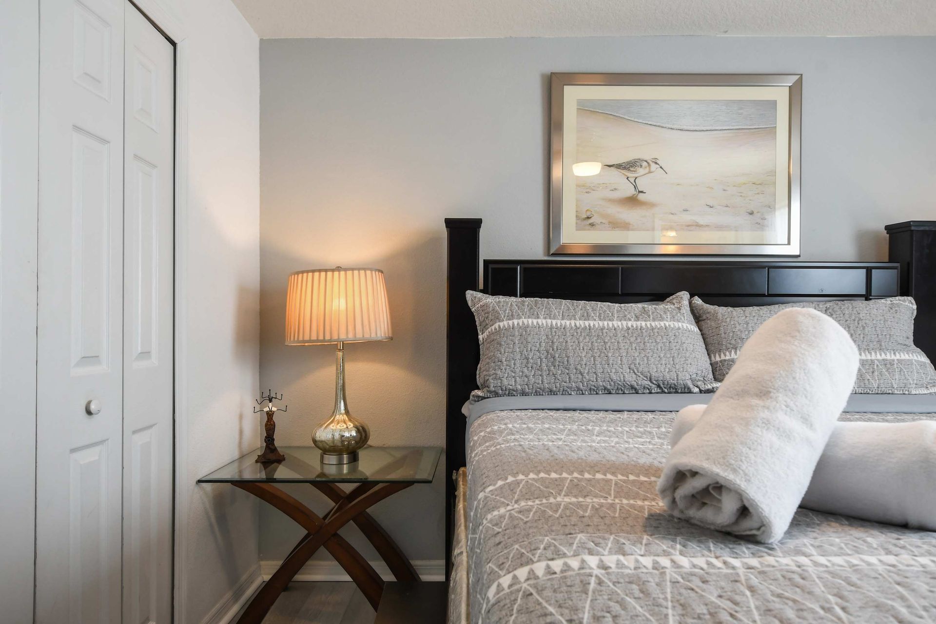 Chic bedroom with elegant decor, soft lighting, and cozy bedding!