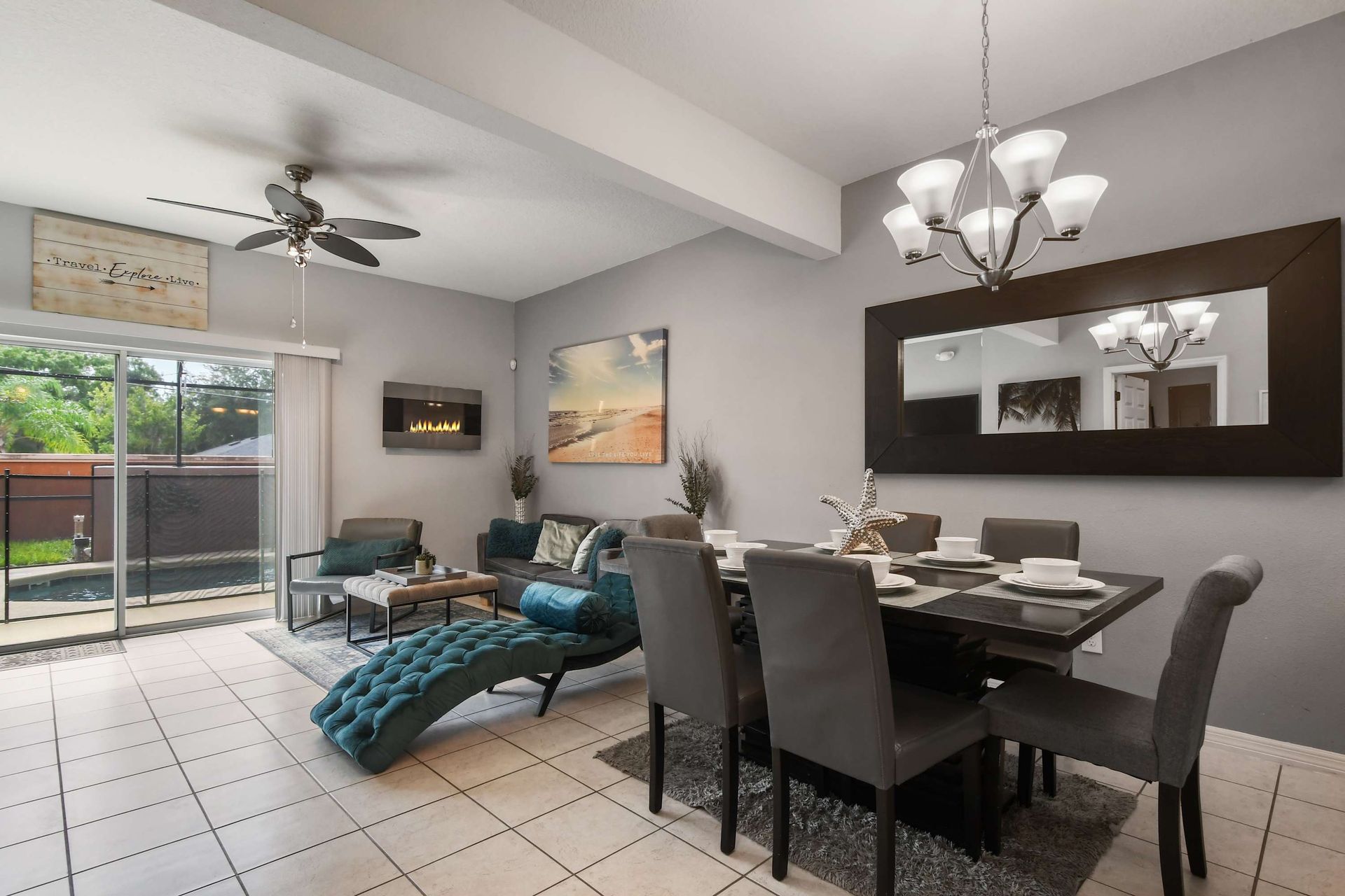 Elegant dining and living space with pool view and cozy fireplace!