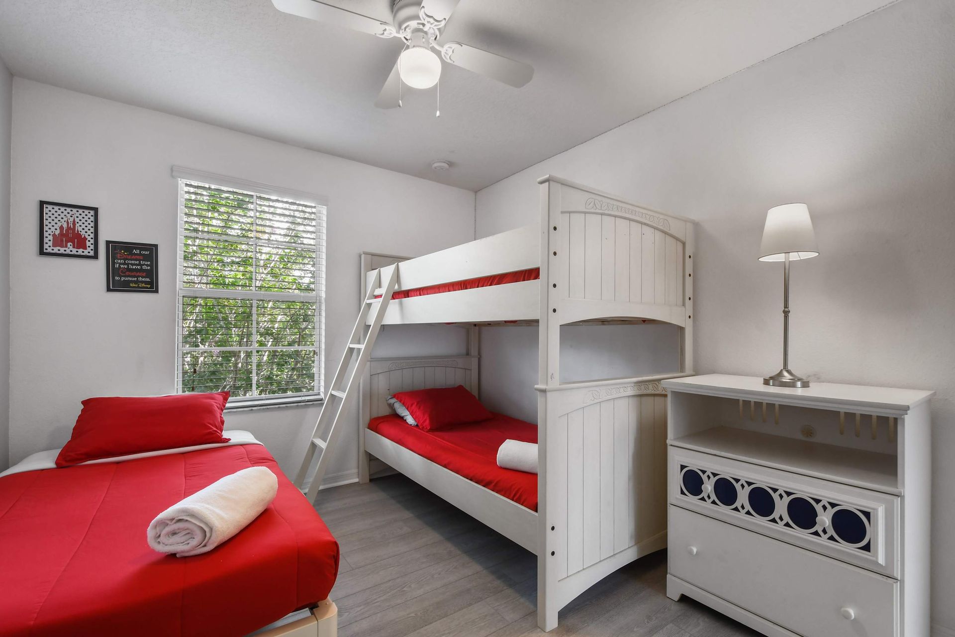 Bright and fun kids' room with bunk beds and cheerful red accents!