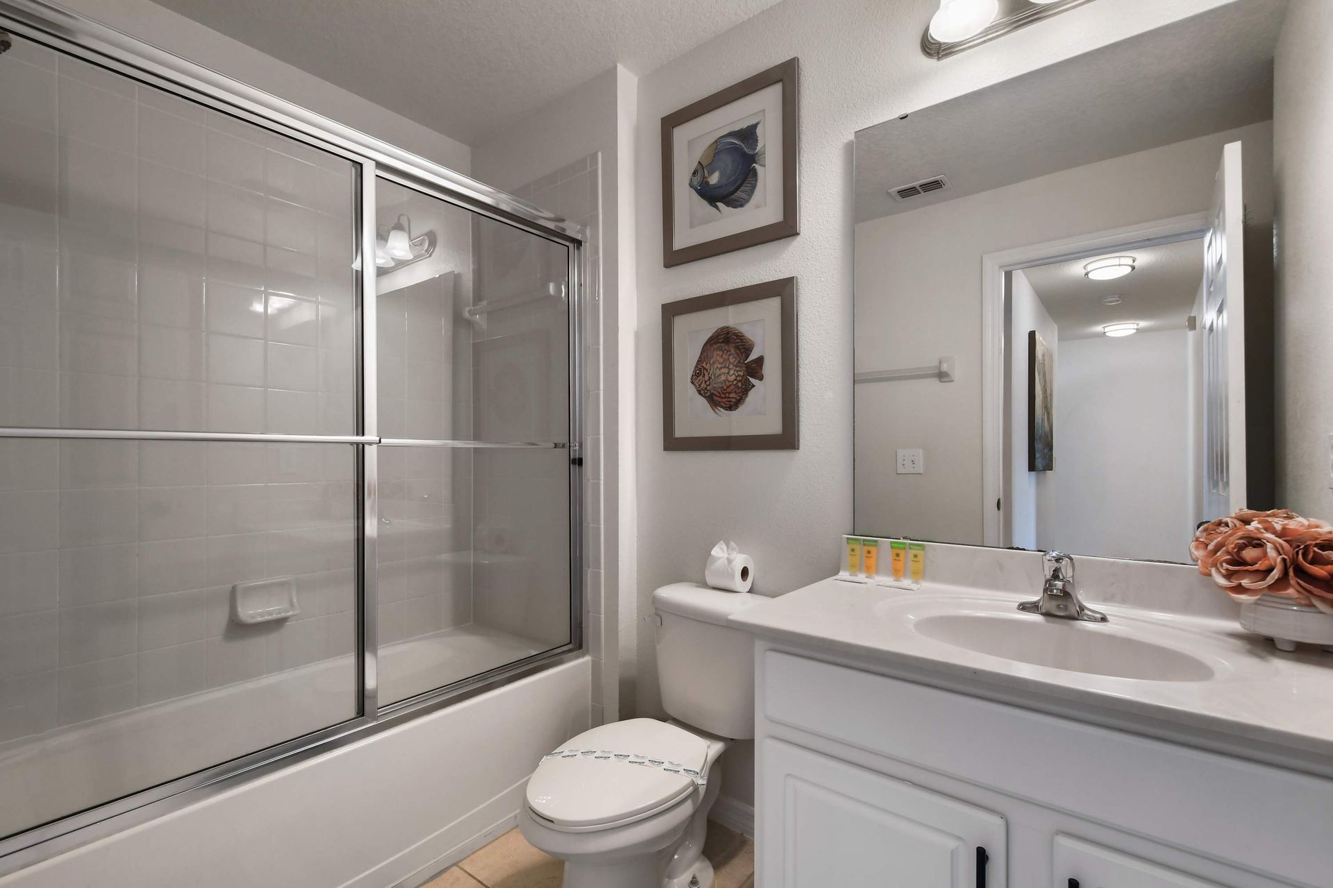 Bright and clean bathroom with a tub, modern accents, and decor!