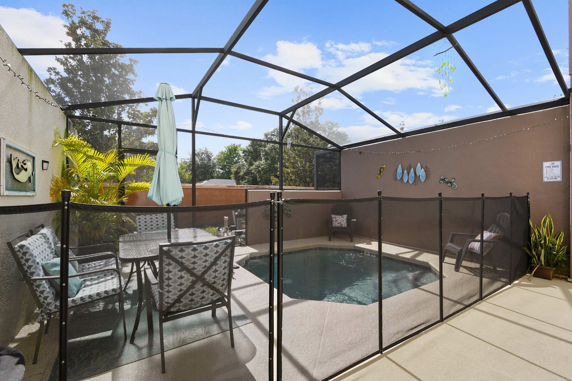 Private screened-in pool with cozy seating and vibrant decor!