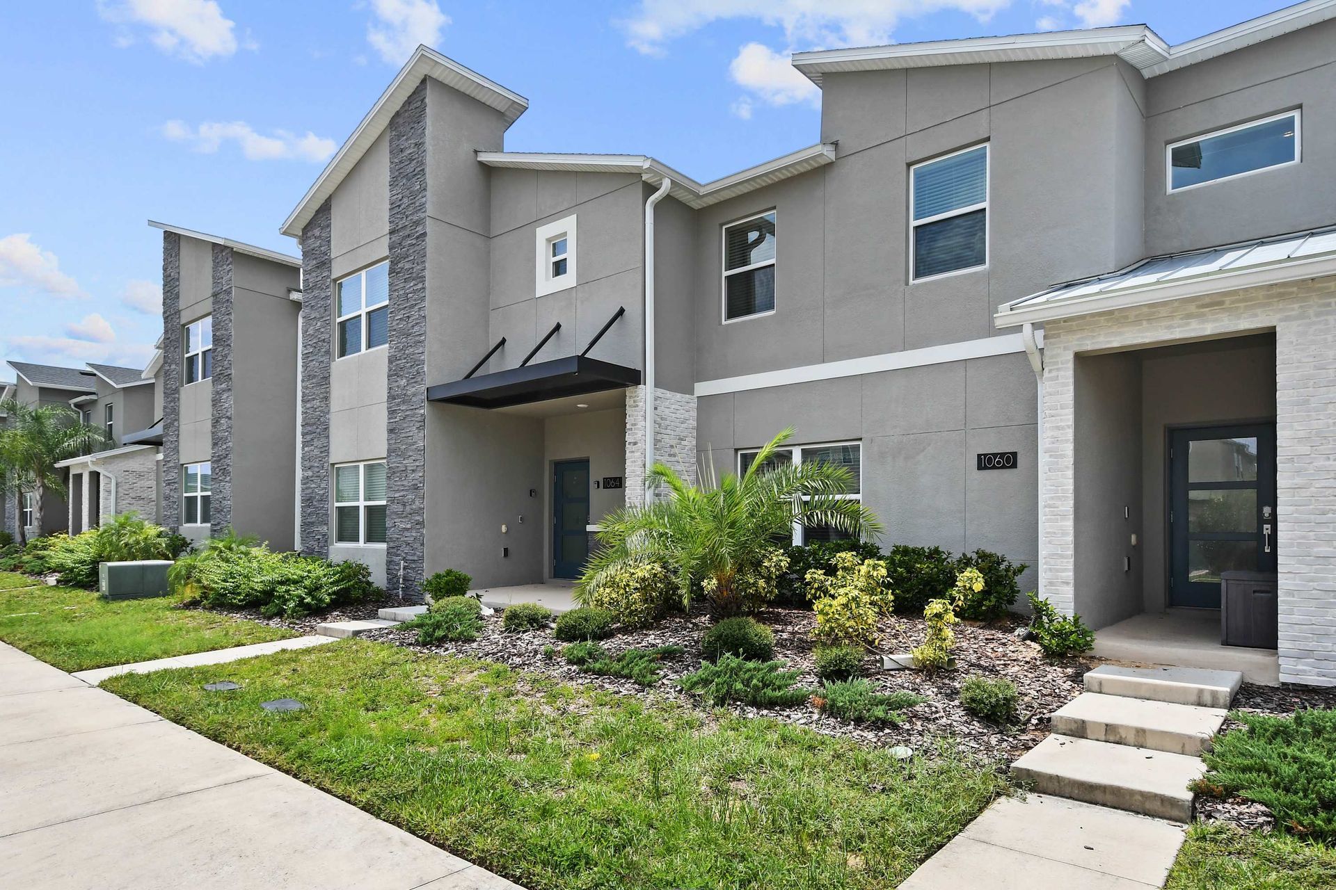 Modern Townhome w/ Stylish Exterior & Lush Landscaping!
