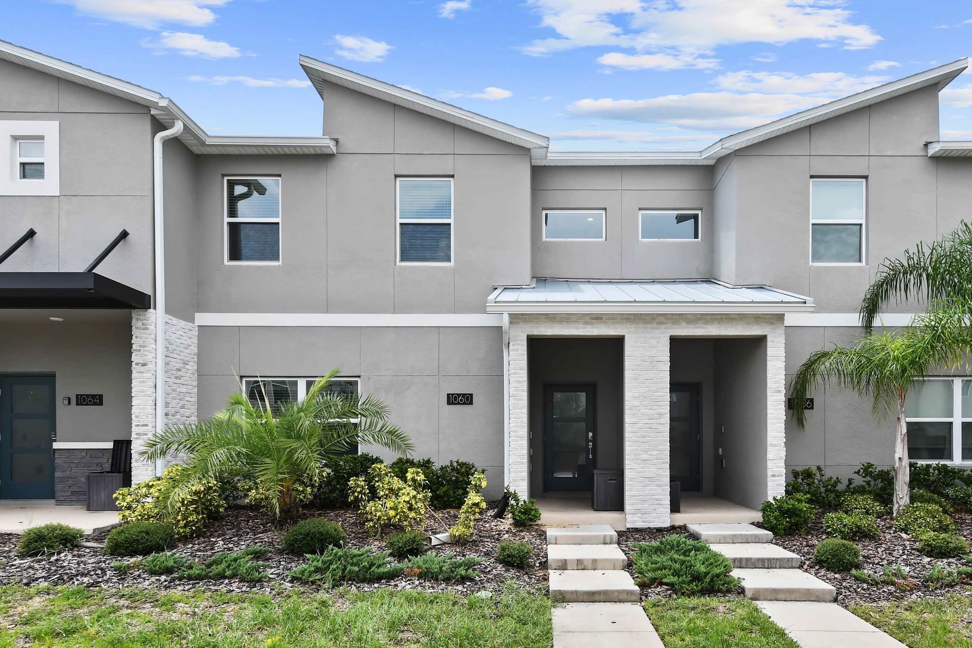Modern Townhome w/ Stylish Exterior & Lush Landscaping!