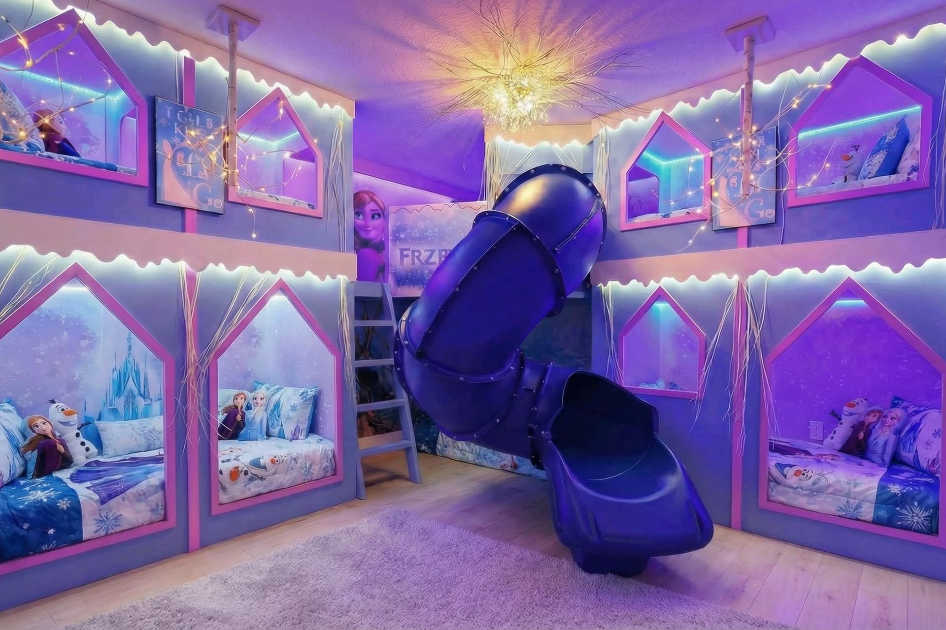Magical winter-themed bunk room with glowing lights, an icy slide, and cozy beds.