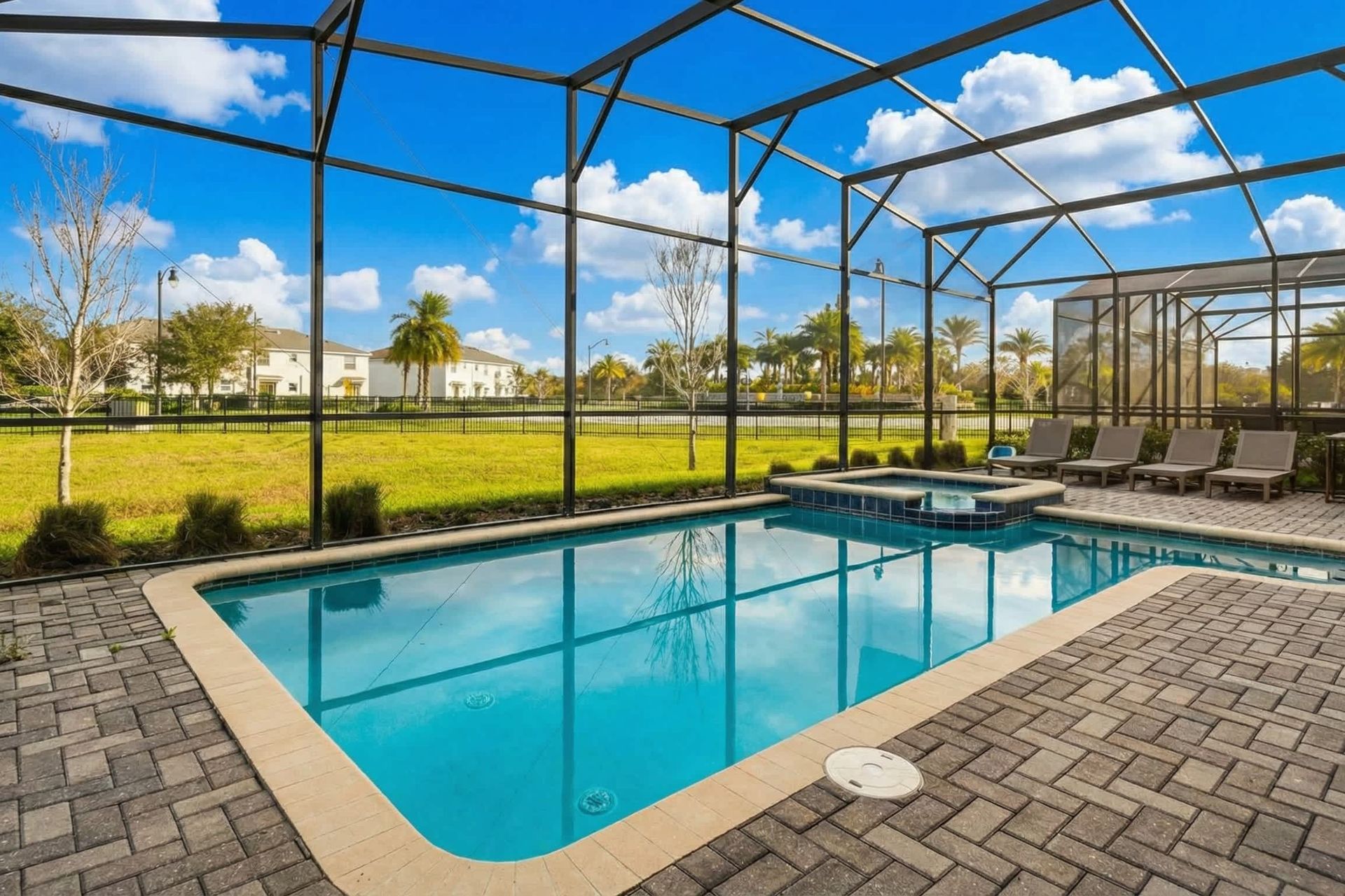 Relax in a private screened-in pool and spa with lounge seating and scenic views.