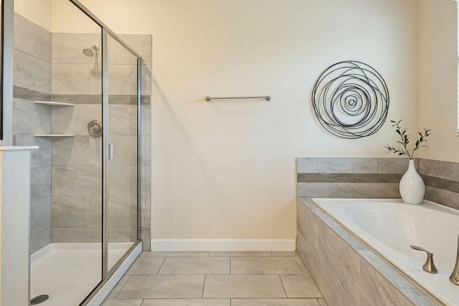 Elegant spa-like bathroom with a spacious glass shower, soaking tub, and modern décor.