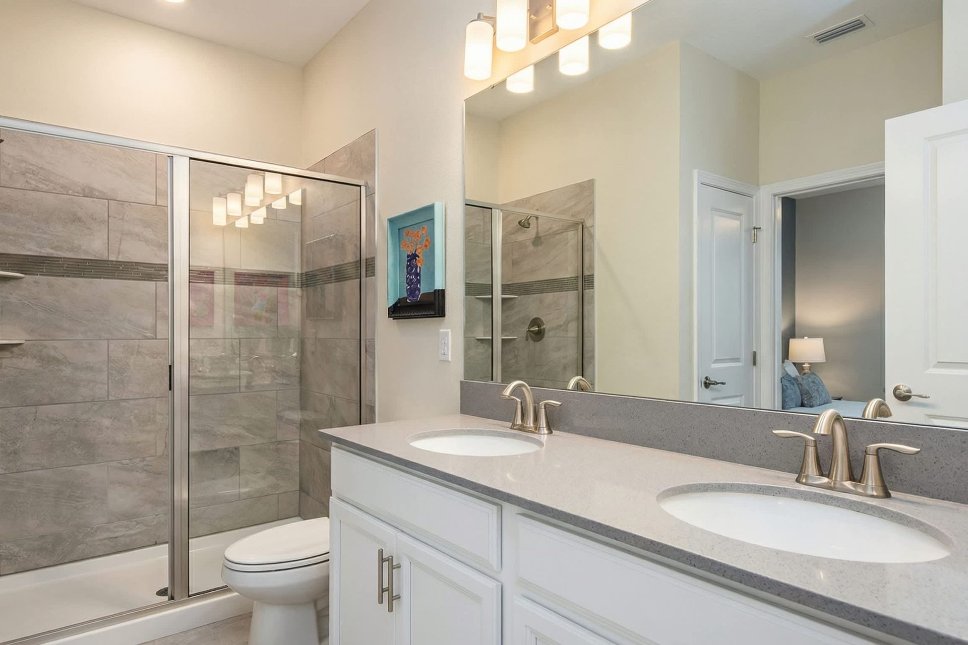 Stylish bathroom with a dual vanity, glass-enclosed shower, and modern finishes.