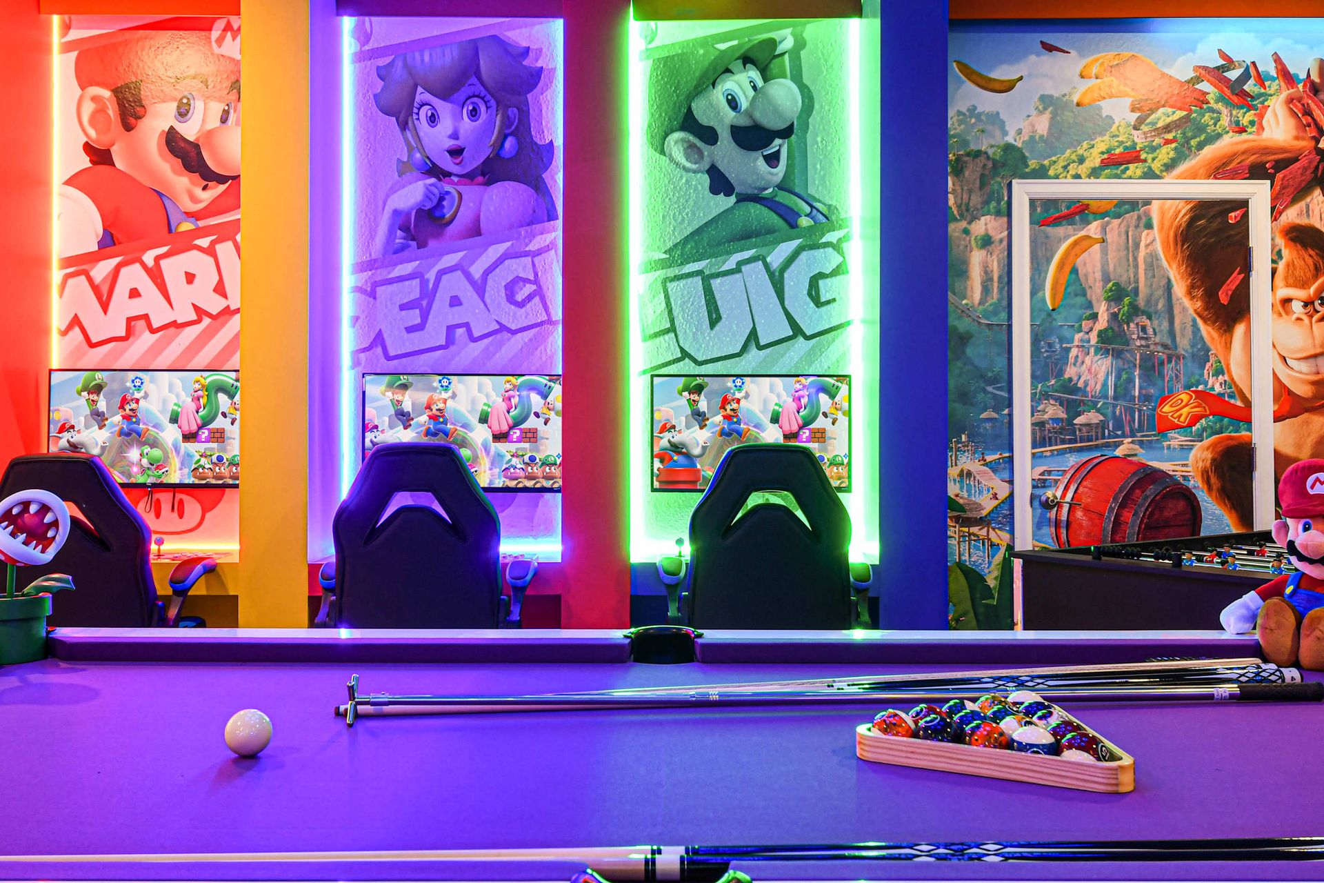 Ultimate gaming paradise with themed décor, neon lights, gaming stations, and a pool table.