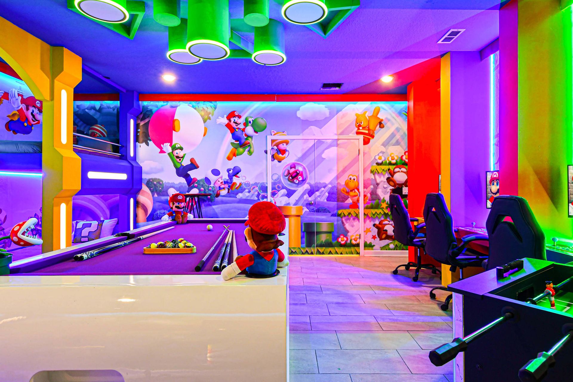 Ultimate gaming paradise with themed décor, neon lights, gaming stations, and a pool table.