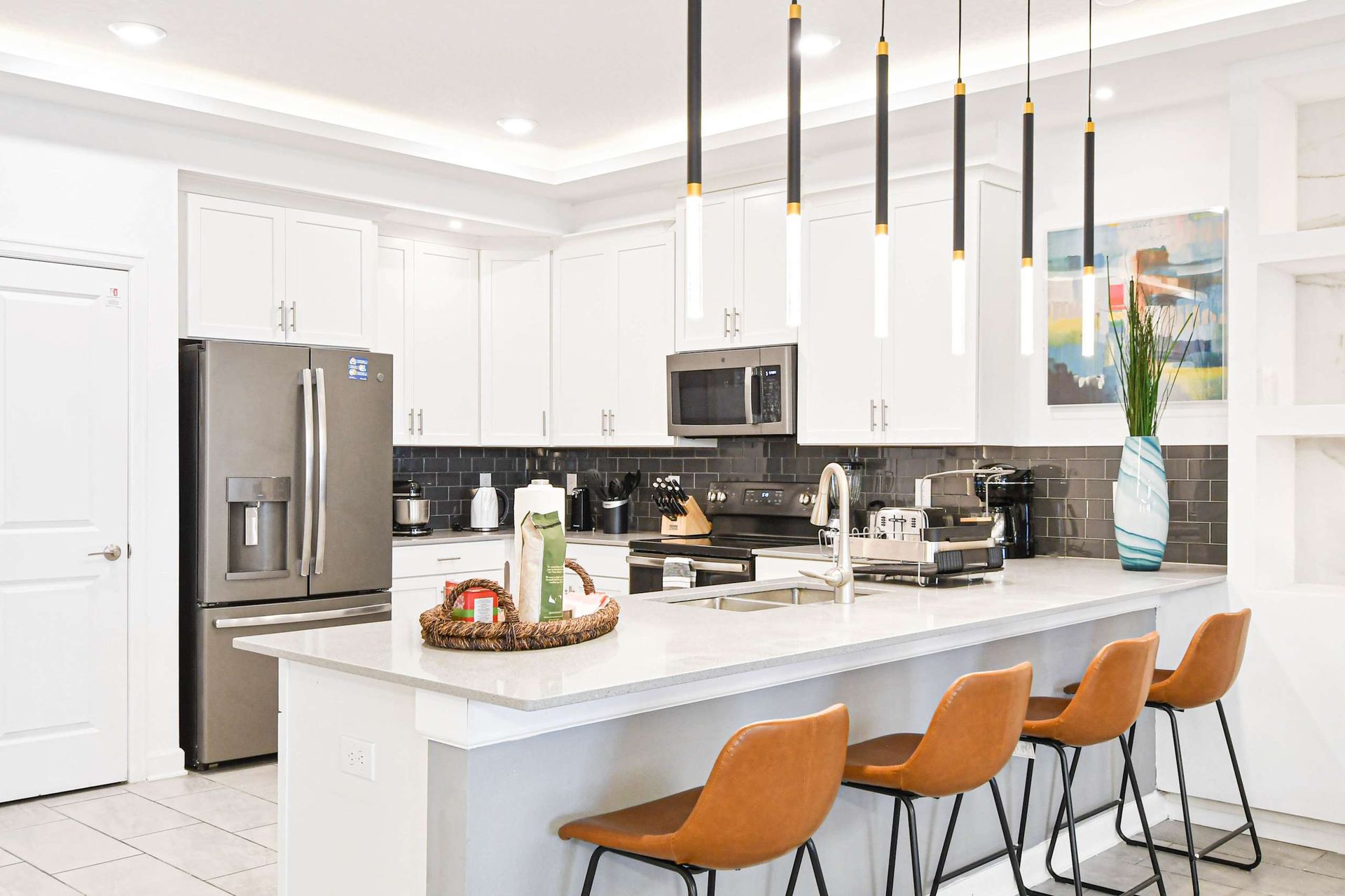 Sleek modern kitchen with high-end appliances, stylish lighting, and a spacious island.
