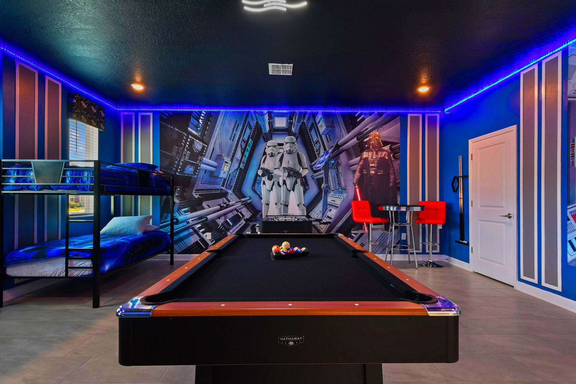 Epic space-themed game room with bunk beds, a pool table, and glowing LED lights.