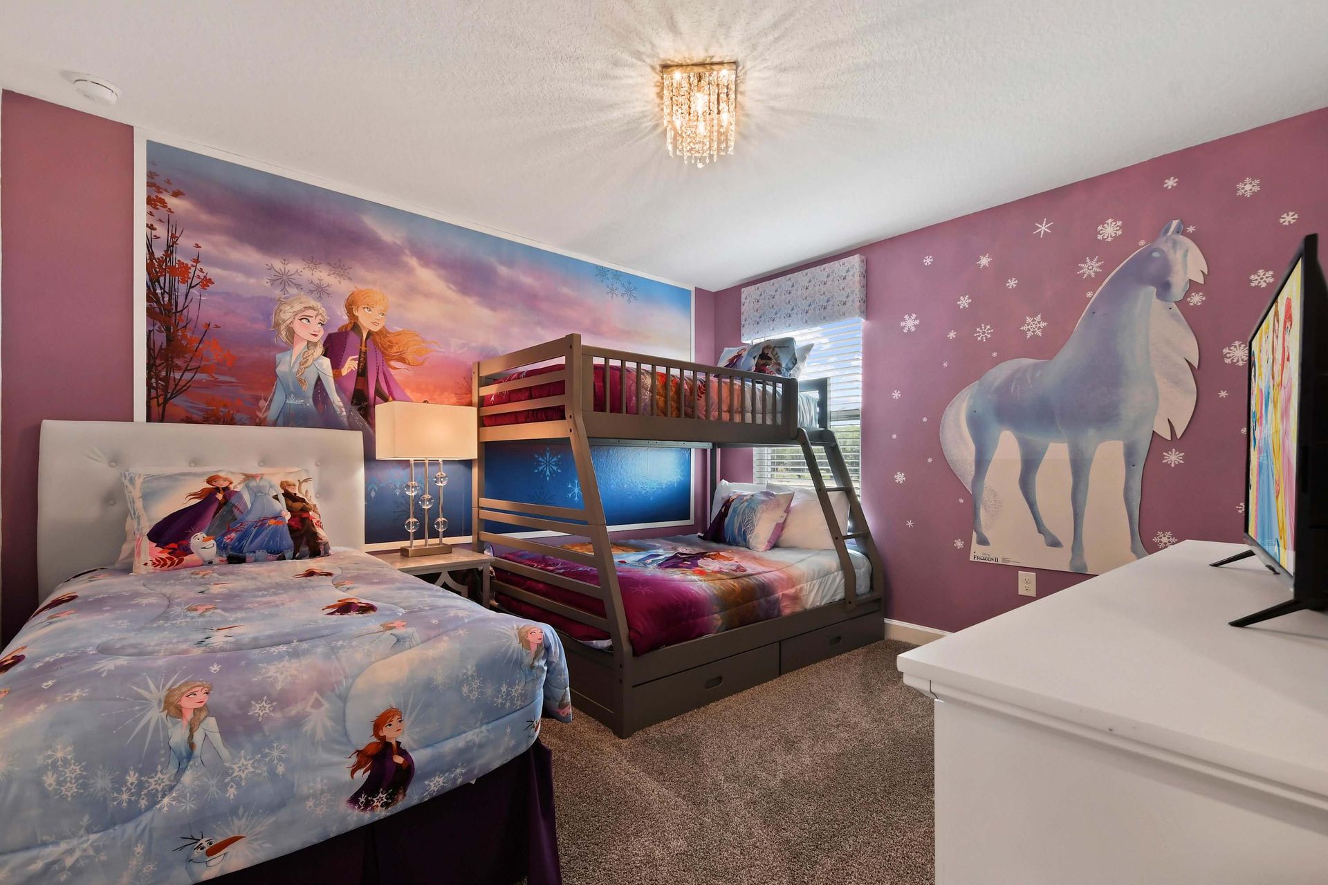 Let the kids immerse themselves in the magic of Disney with this Frozen-themed bedroom, complete with cozy bunk beds and vibrant decor to bring the movie to life.