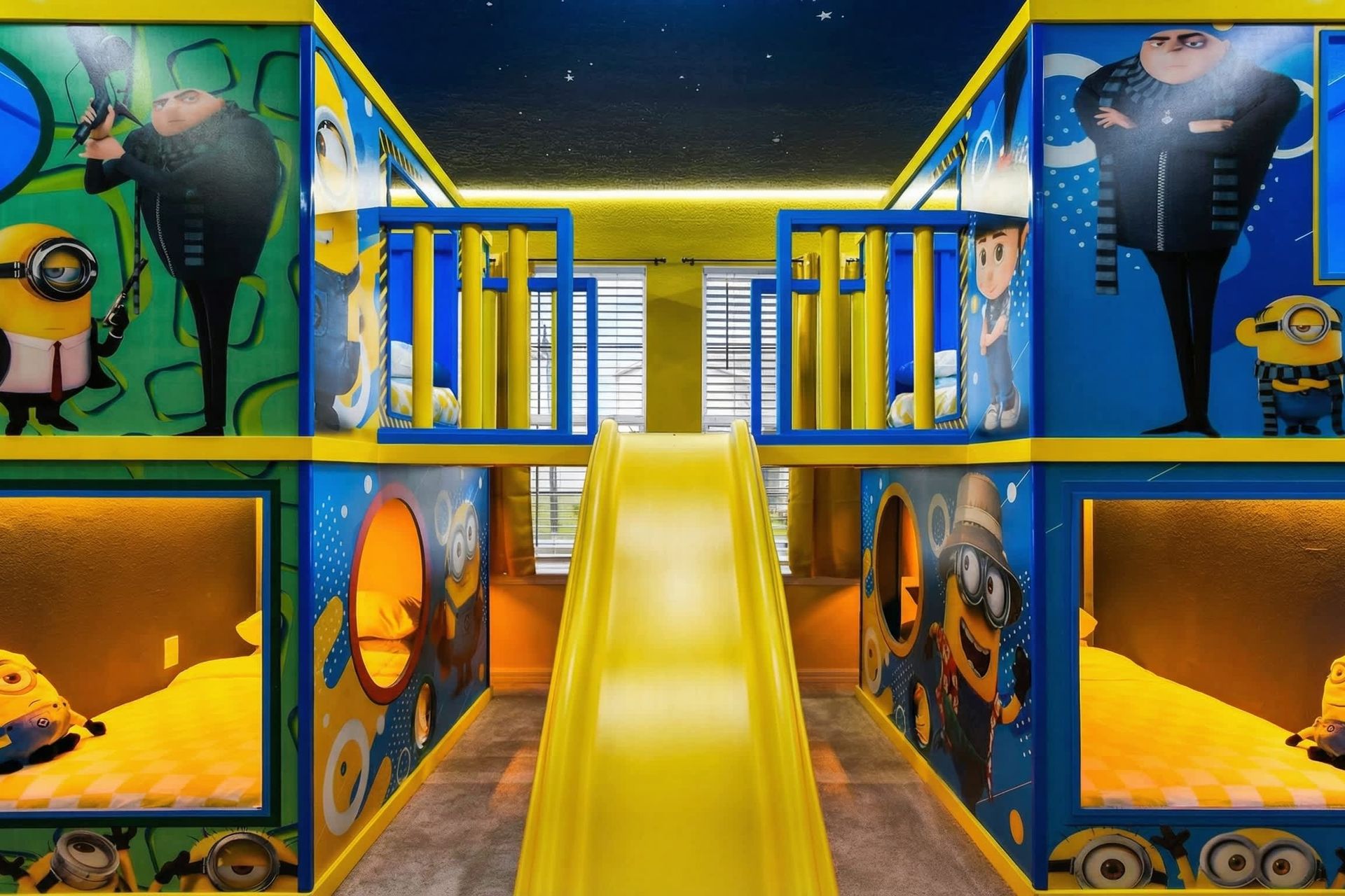 Minion-themed bunk room with slide, murals, and built-in beds for nonstop fun.