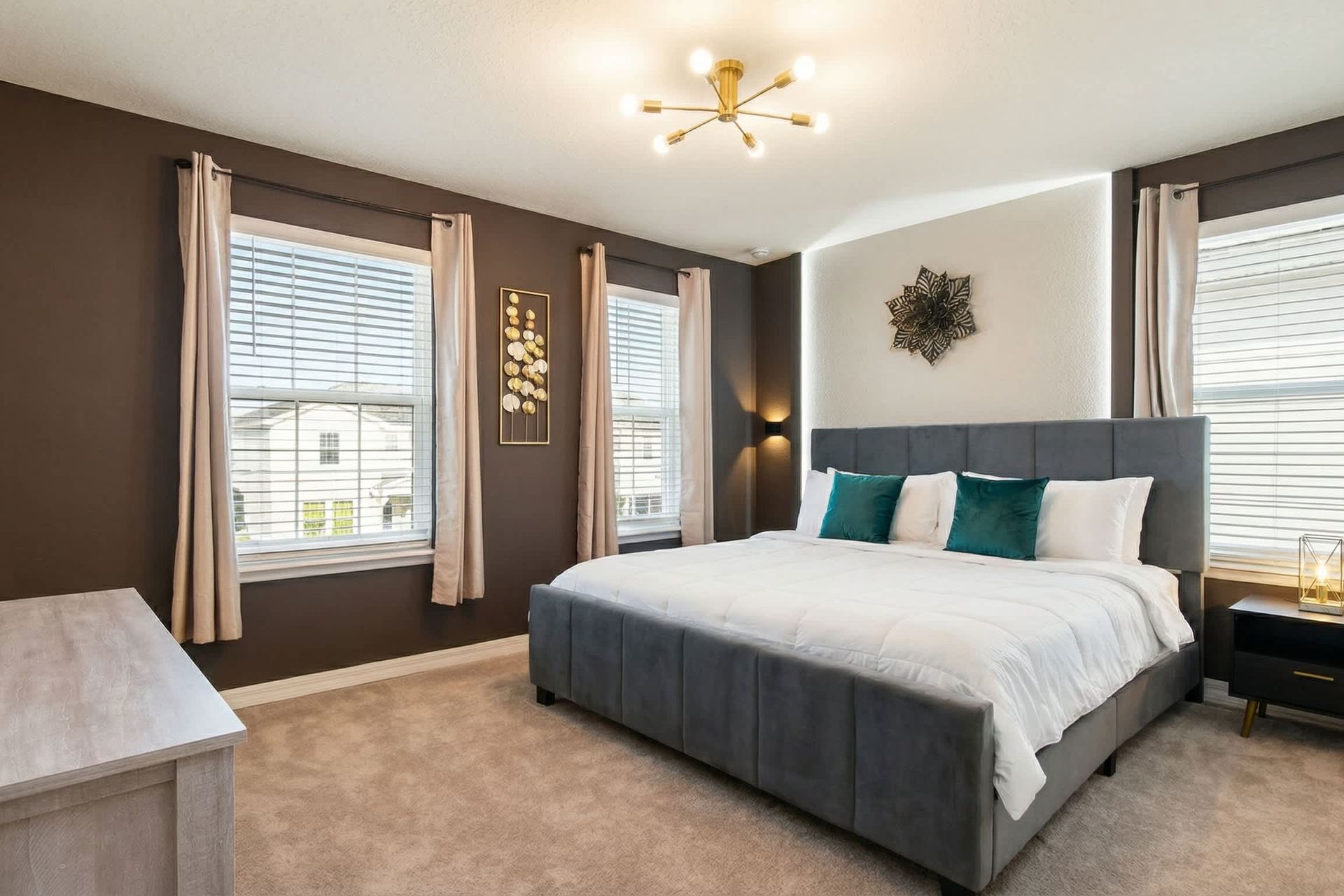 Chic and cozy bedroom with a plush king bed, bold accents, and natural light.