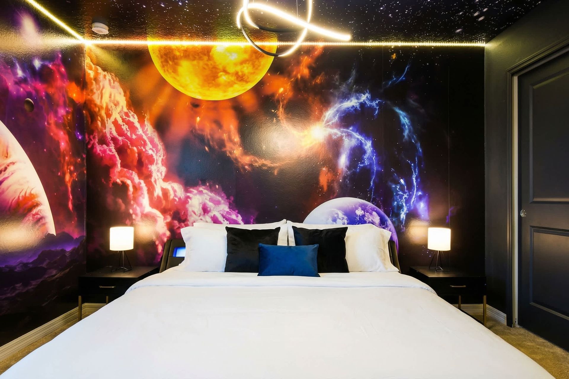 Immerse yourself in a cosmic retreat with this galaxy-themed king suite.